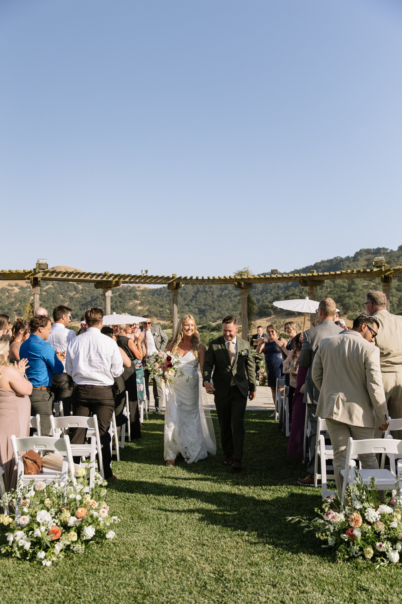 Bride and groom walking down aisle by wedding photographer Northern California