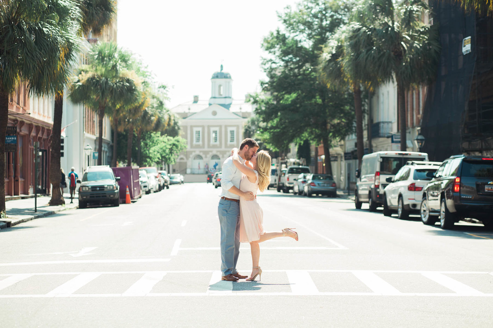 Engaged couple stops to kiss on Broad Street, Downtown Charleston, South Carolina