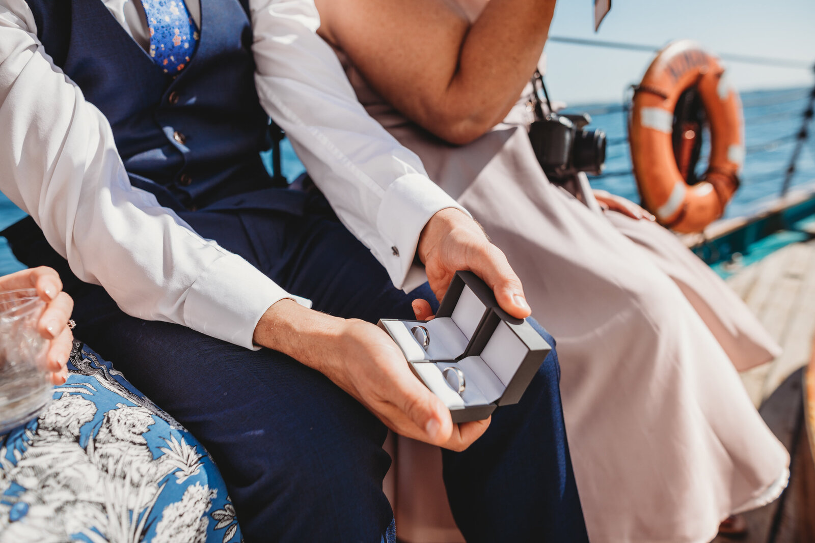 man holds two male wedding rings at elopement