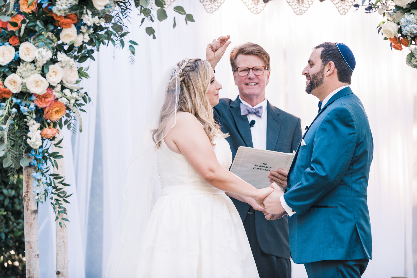 mother walks hand in hand with daughter and holds small child at Myrtle Beach beautiful moment with family photographer jamie lucido