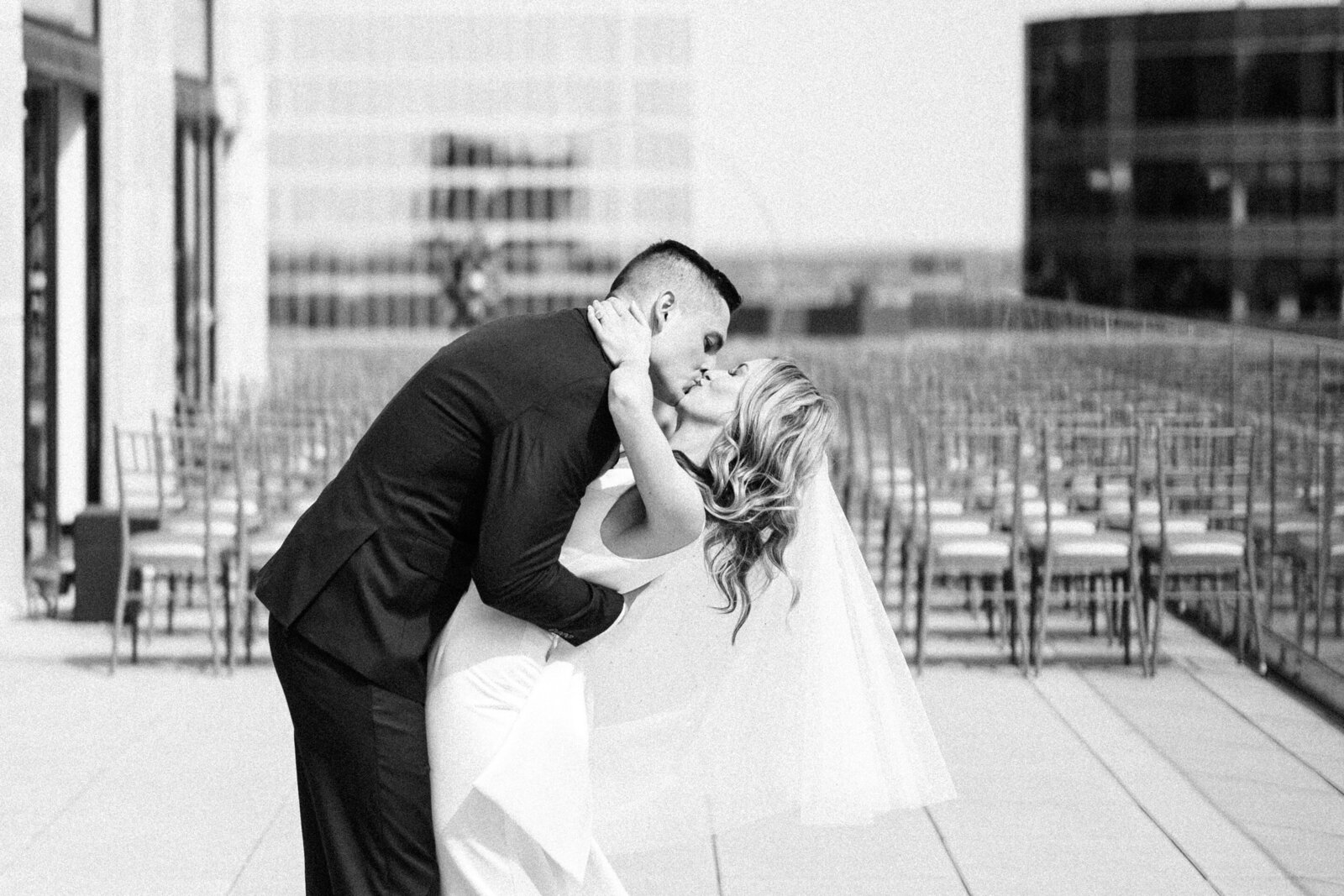 Bride and groom kiss on the Starlight Terrace at Hotel Kansas City