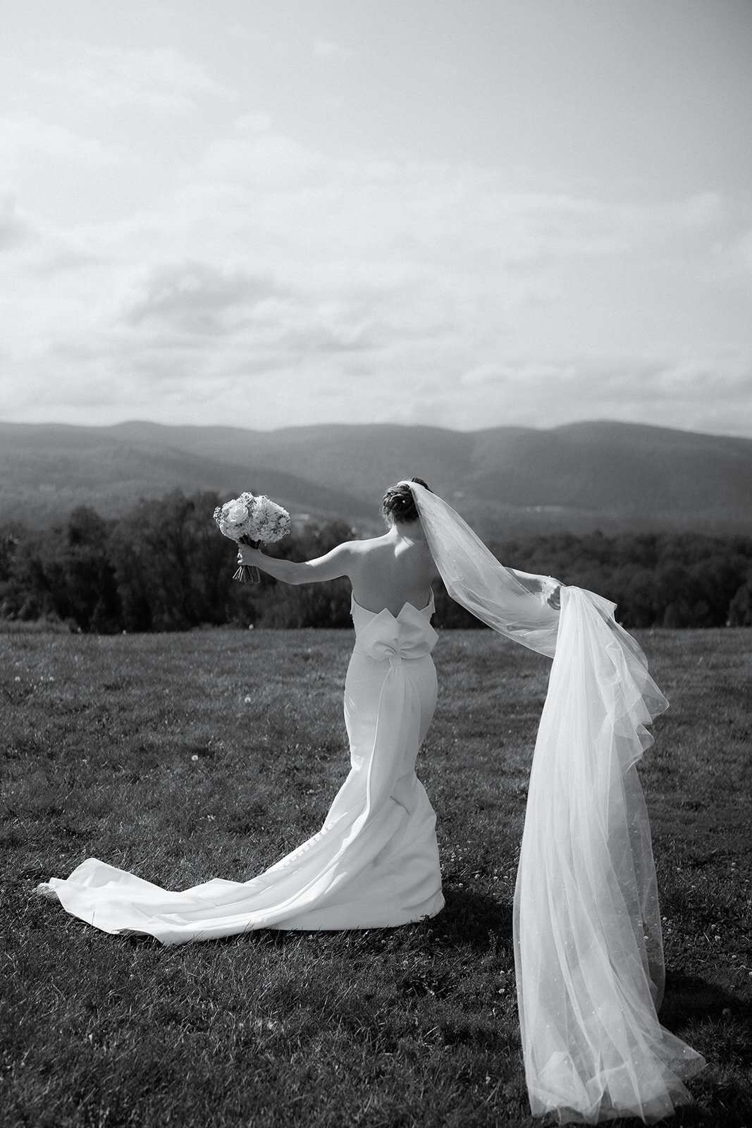Bride in New Jersey with bouquet and long veil in documentary wedding photo