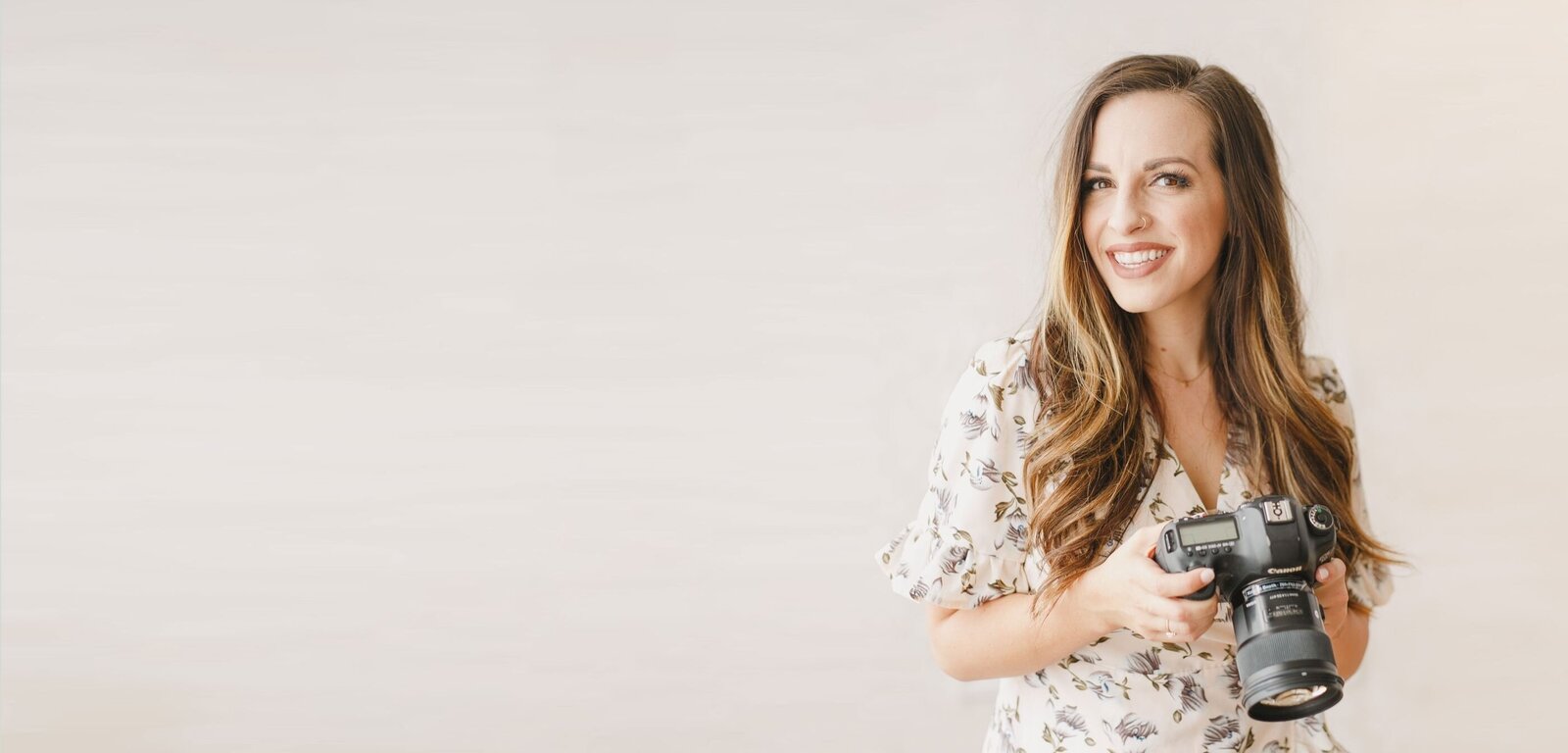 Portrait of Kristen Booth (The Fairytale Photographer) holding Canon DSLR camera