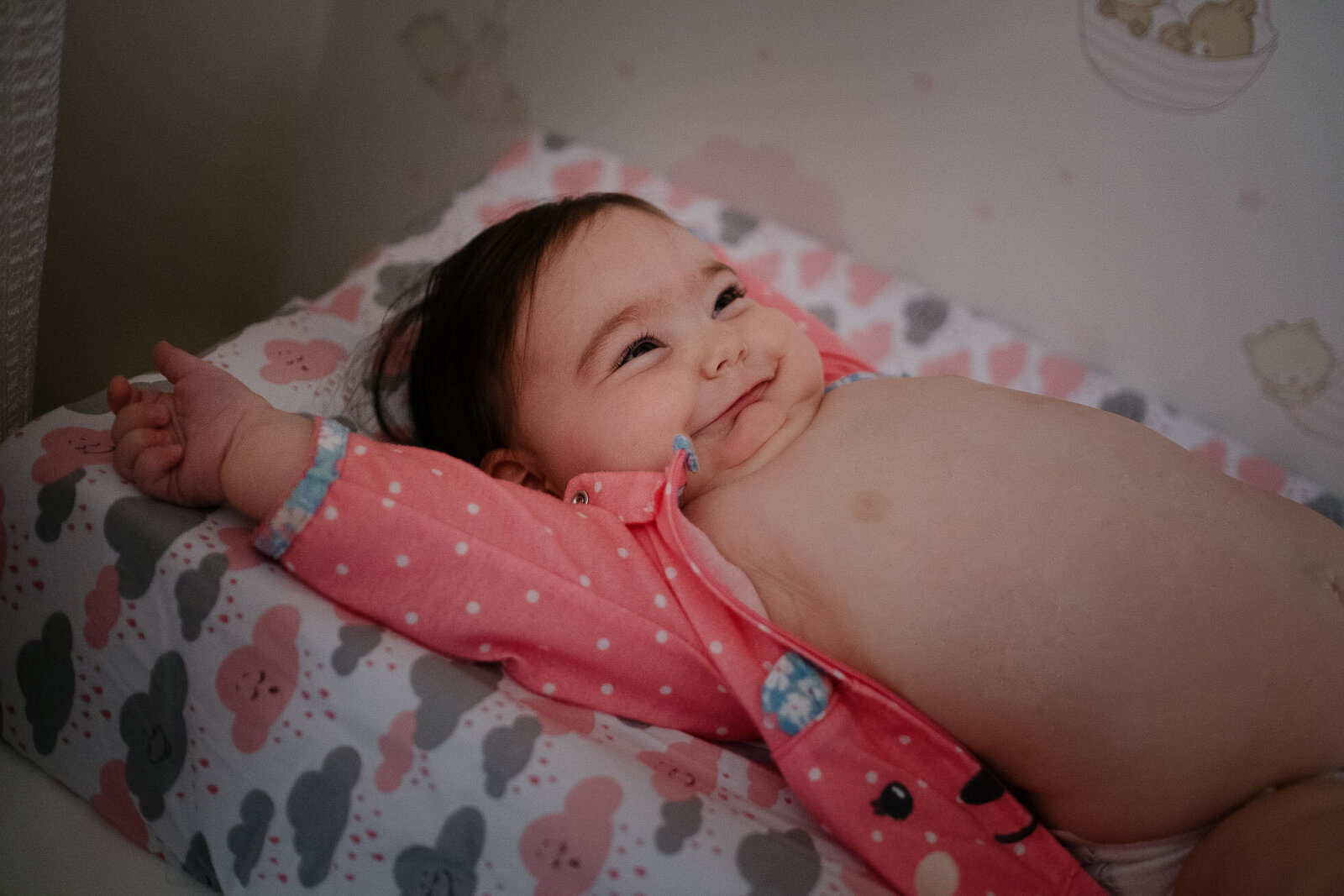 baby stretches in her changing table