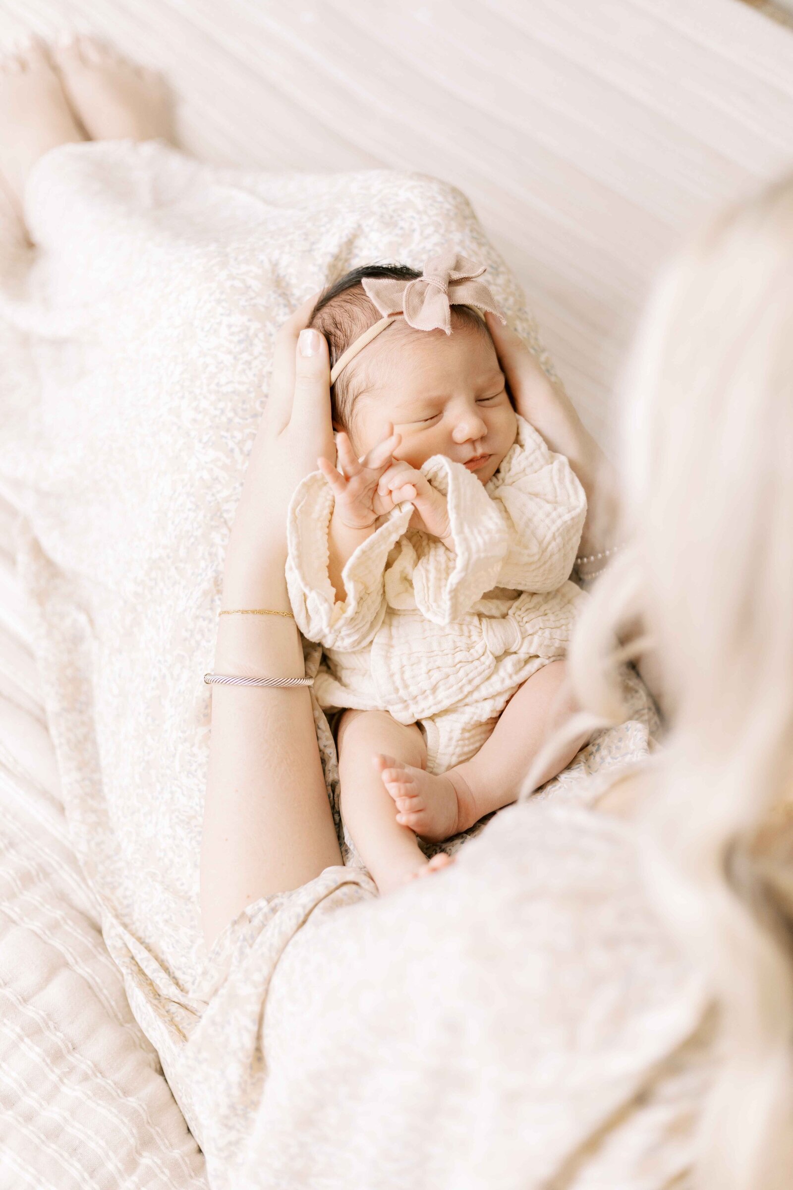 newborn baby on mom's lap in newborn photos in peoria illinois