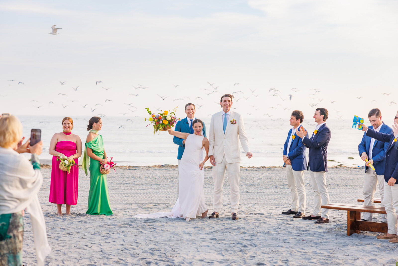 Bride and Groom Celebrate on a Beach in Newport, Rhode Island - Eventlightenment Wedding Planning