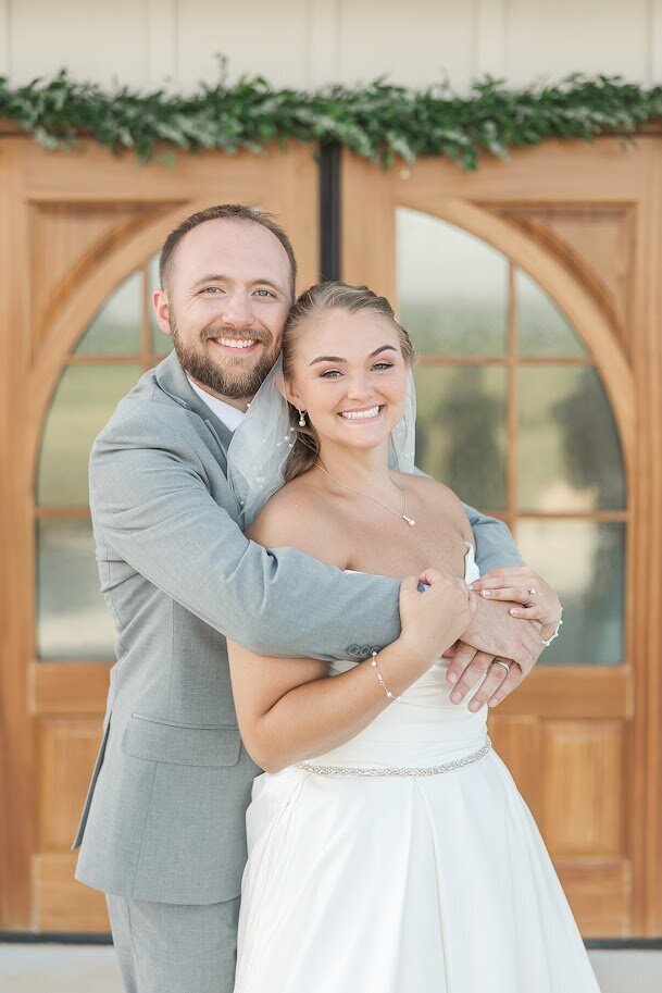Bride-Groom-Hugging-Double-Doors-The-Legacy-At-Willow-Pond