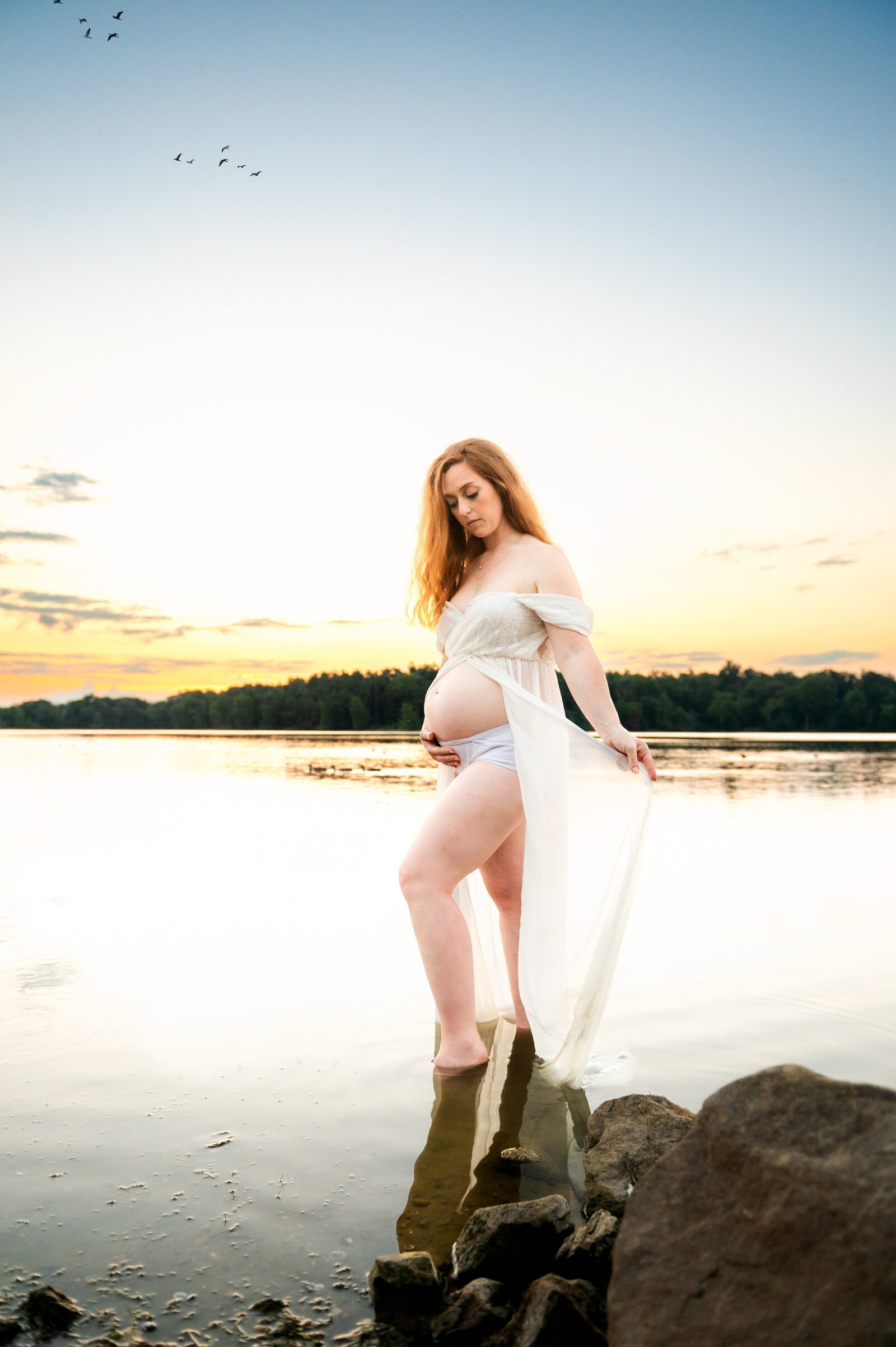 woman in a sheer maternity dress in the water