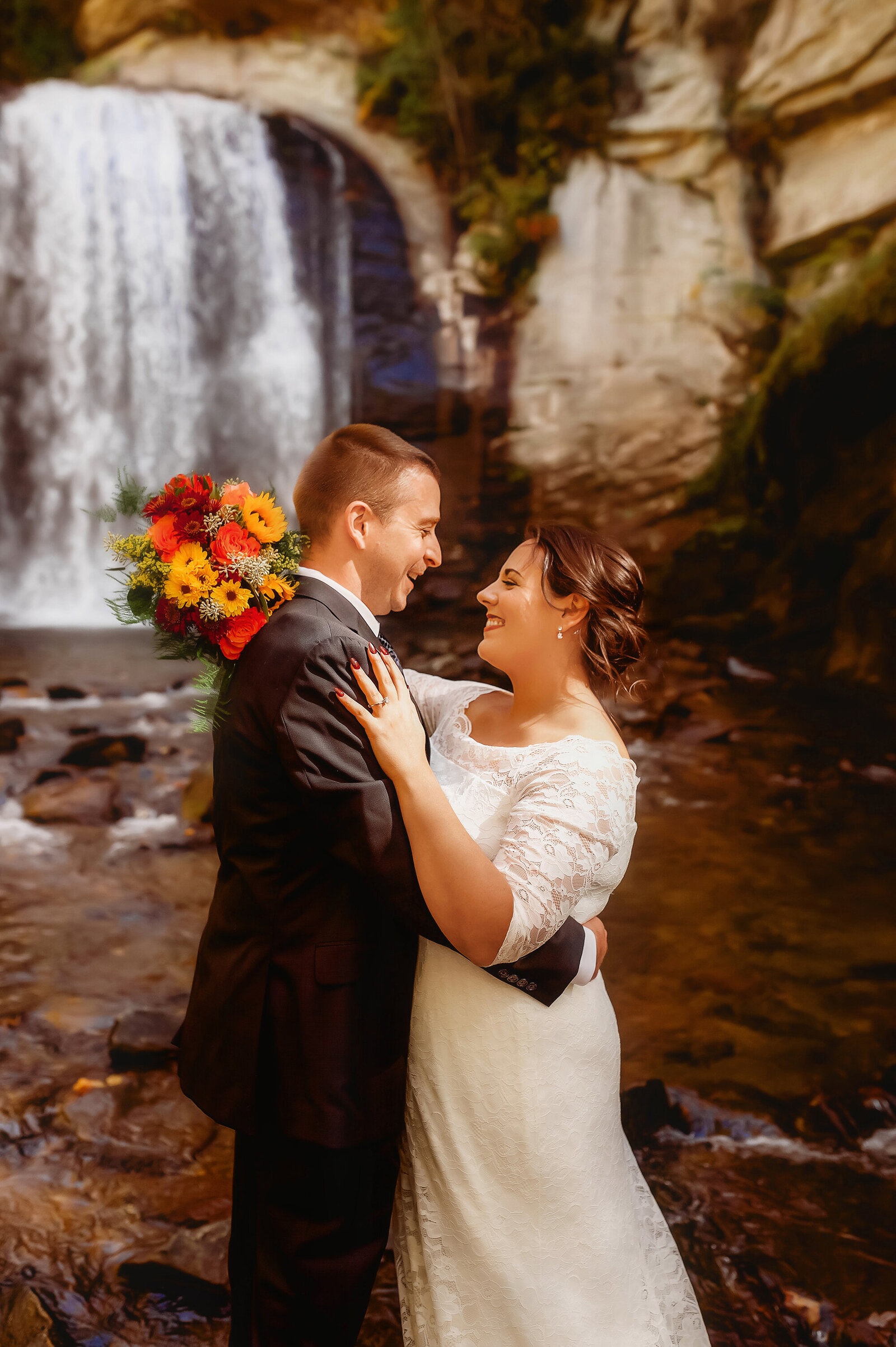 Bride and Groom embrace during their Elopement at Looking Glass Falls in Brevard, NC.