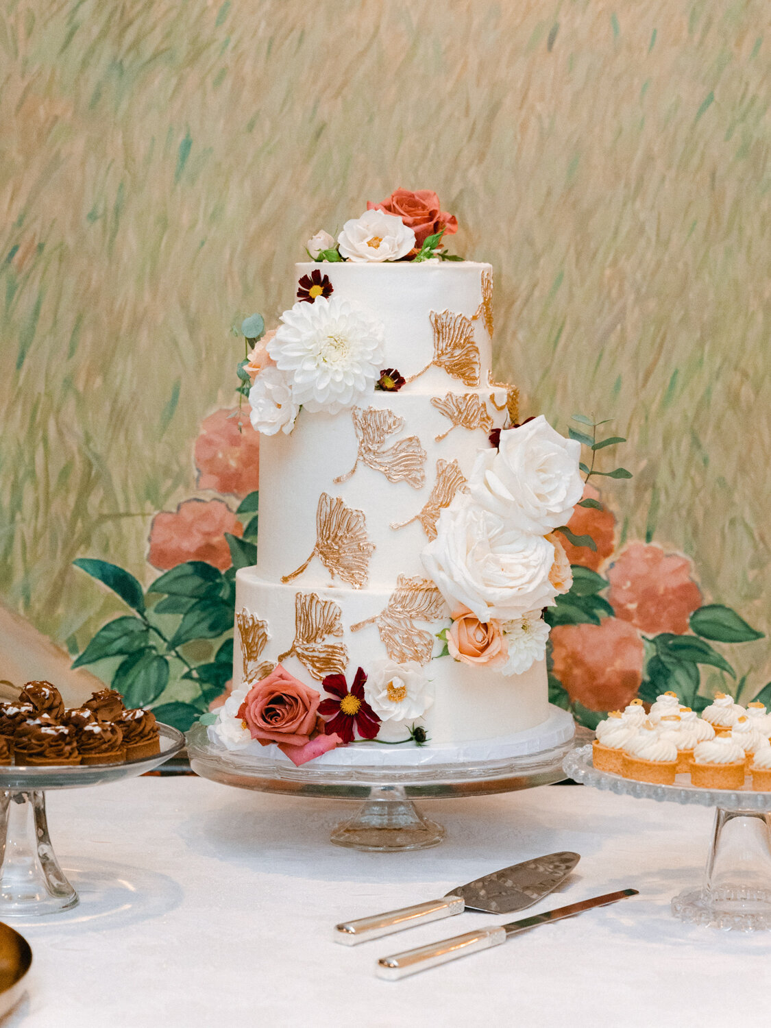 A beautiful white wedding cake with flowers decorating it.
