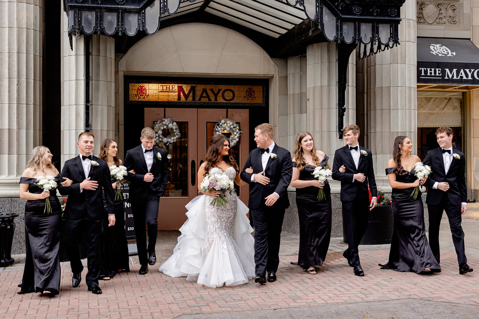 Mayo hotel wedding in downtown Tulsa Oklahoma featuring a black and white themed wedding with black bridesmaids dresses at urban downtown city venue