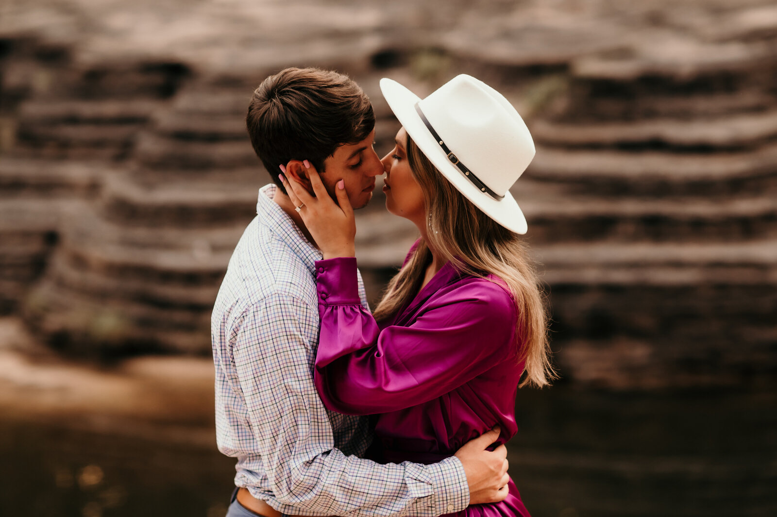 man and woman kissing romantically in little rock ar for their engagement  photos