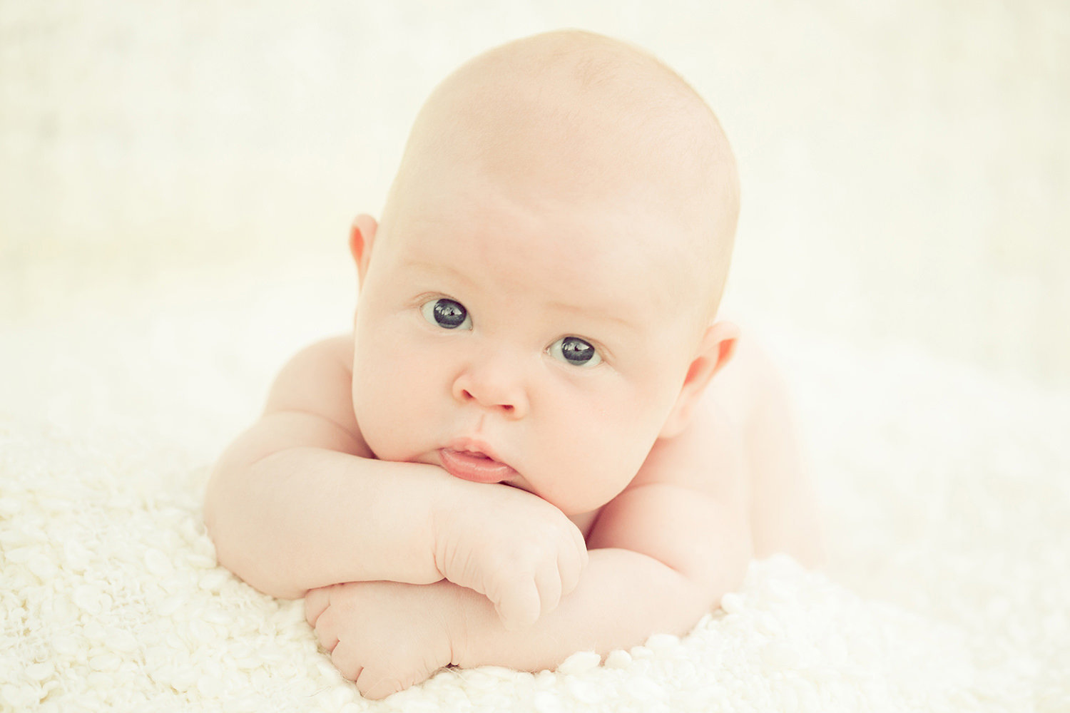 san diego newborn photographer  | newborn with all white background big baby blue eyes