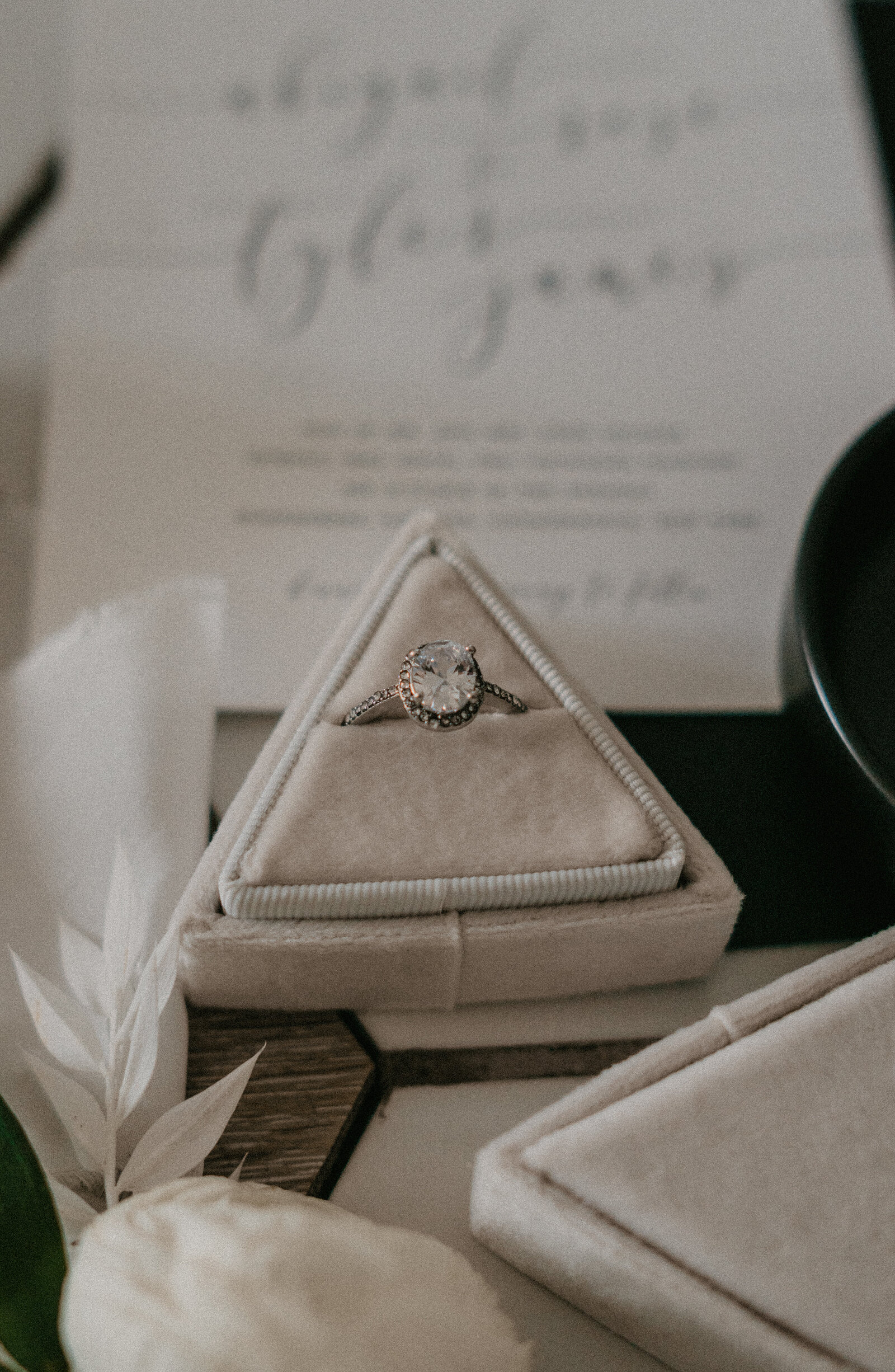 Details of wedding day including invitations, engagement ring and loose florals.