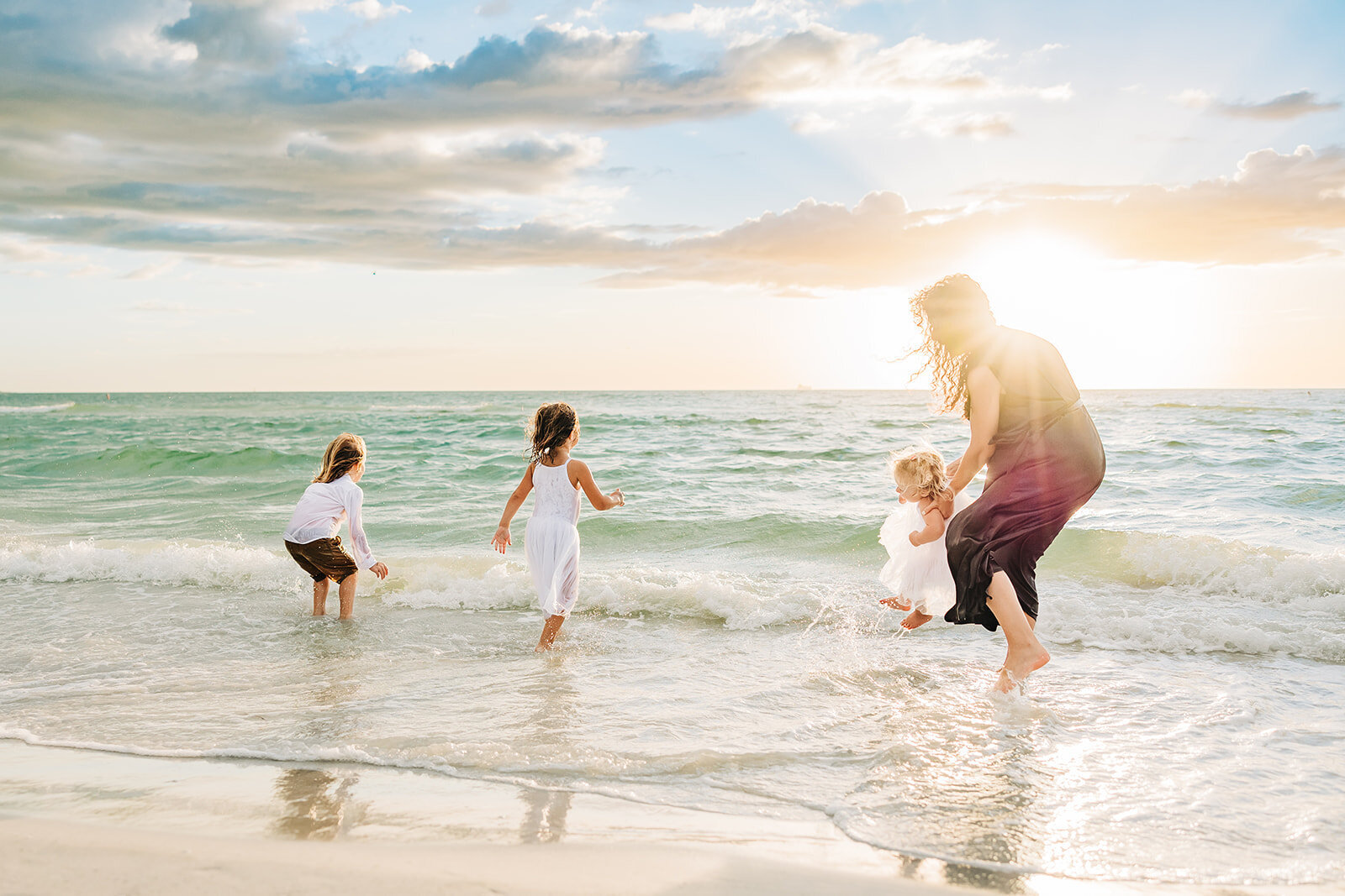 St Pete Family phographer  takes natural candid moment of this mother with 3 kids
