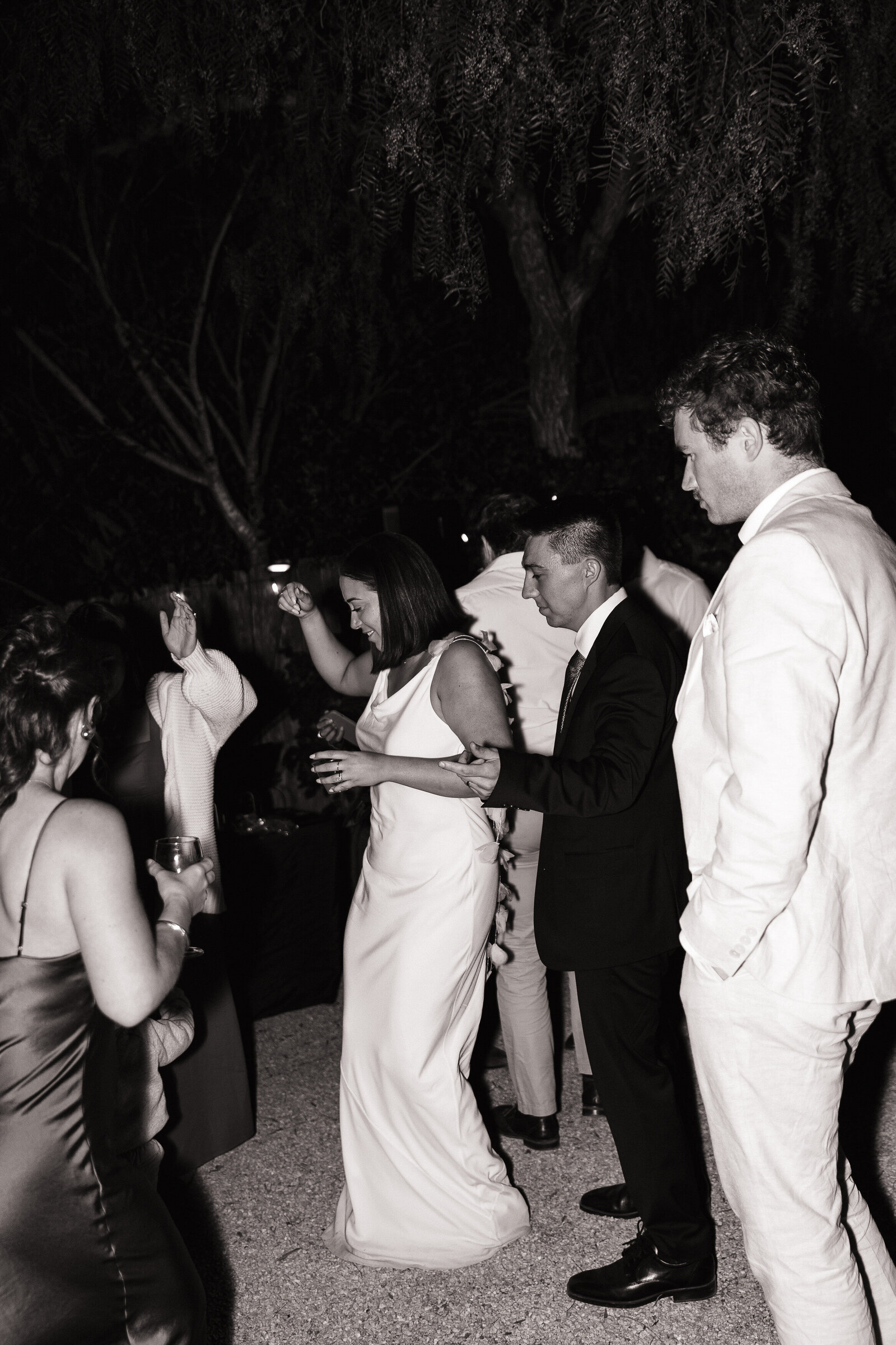 Guests dance with bride and groom during Santa Barbara outdoor wedding reception