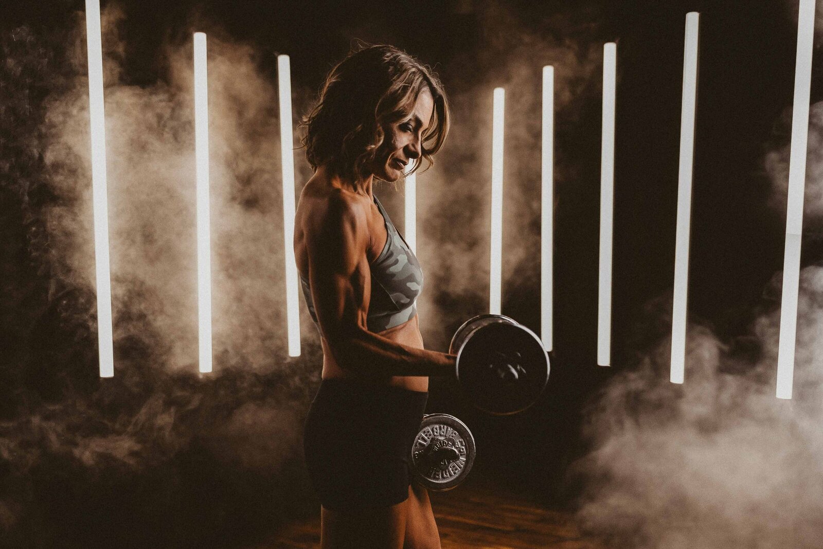 fit woman lifting a dumbell
