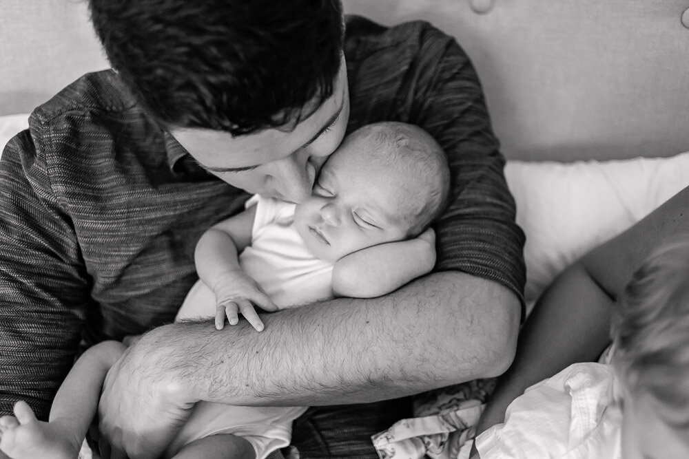 Father kissing baby boy's cheek