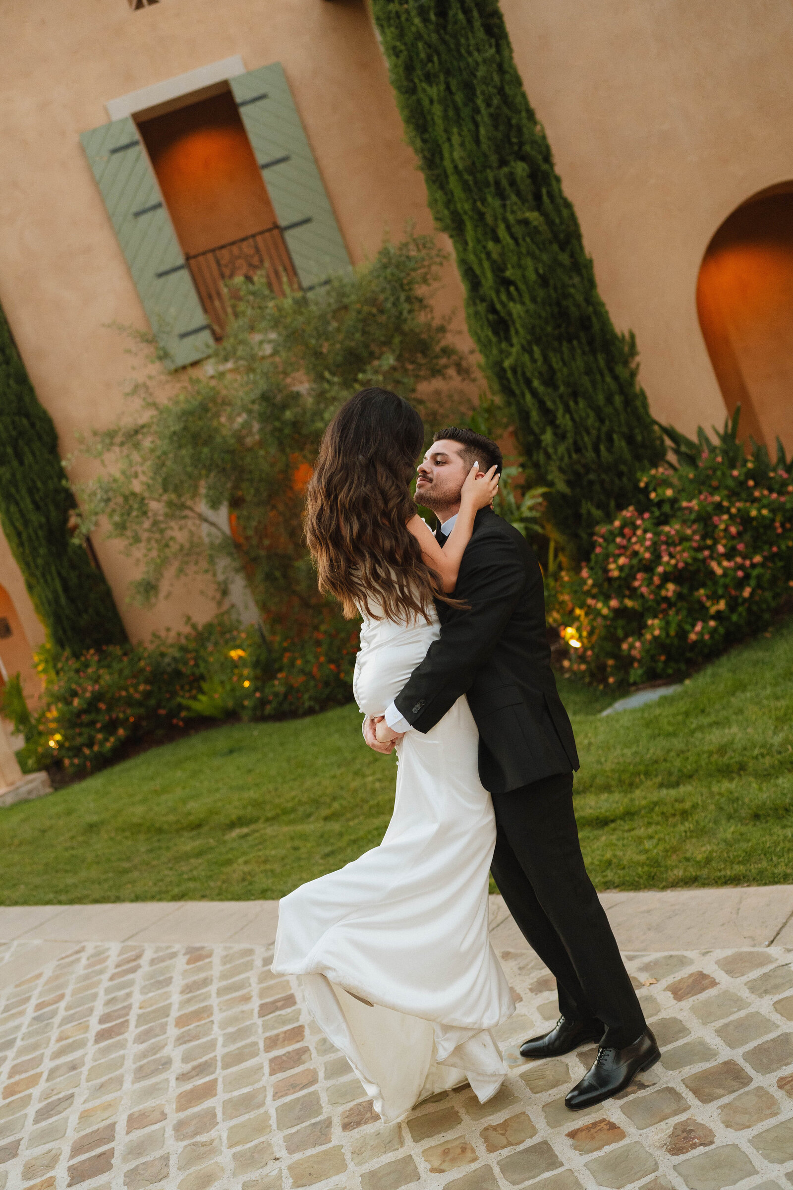 a groom picking up a bride on their wedding day 