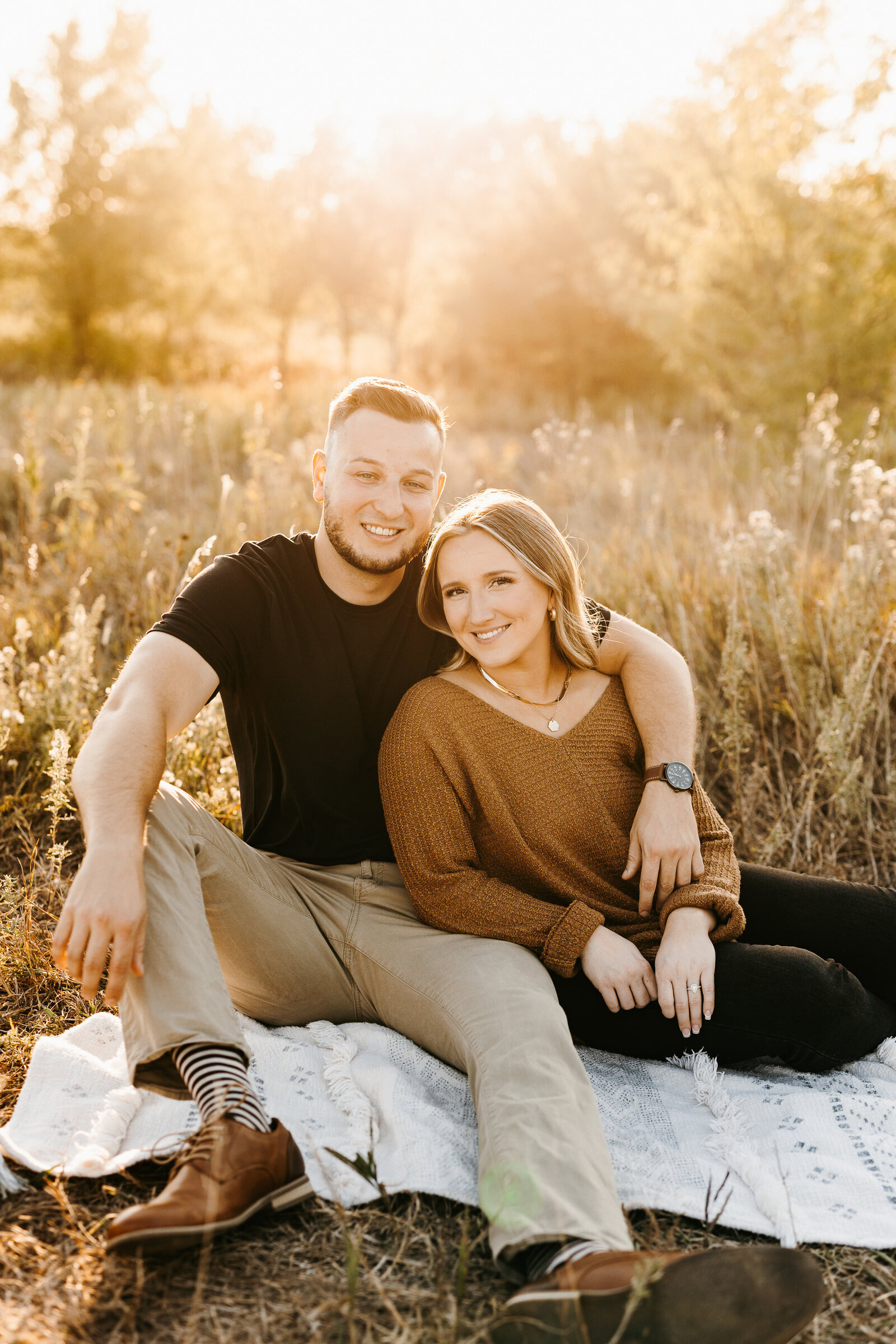 Engaged couple sitting in a wheat field  - Alex Bo Photo