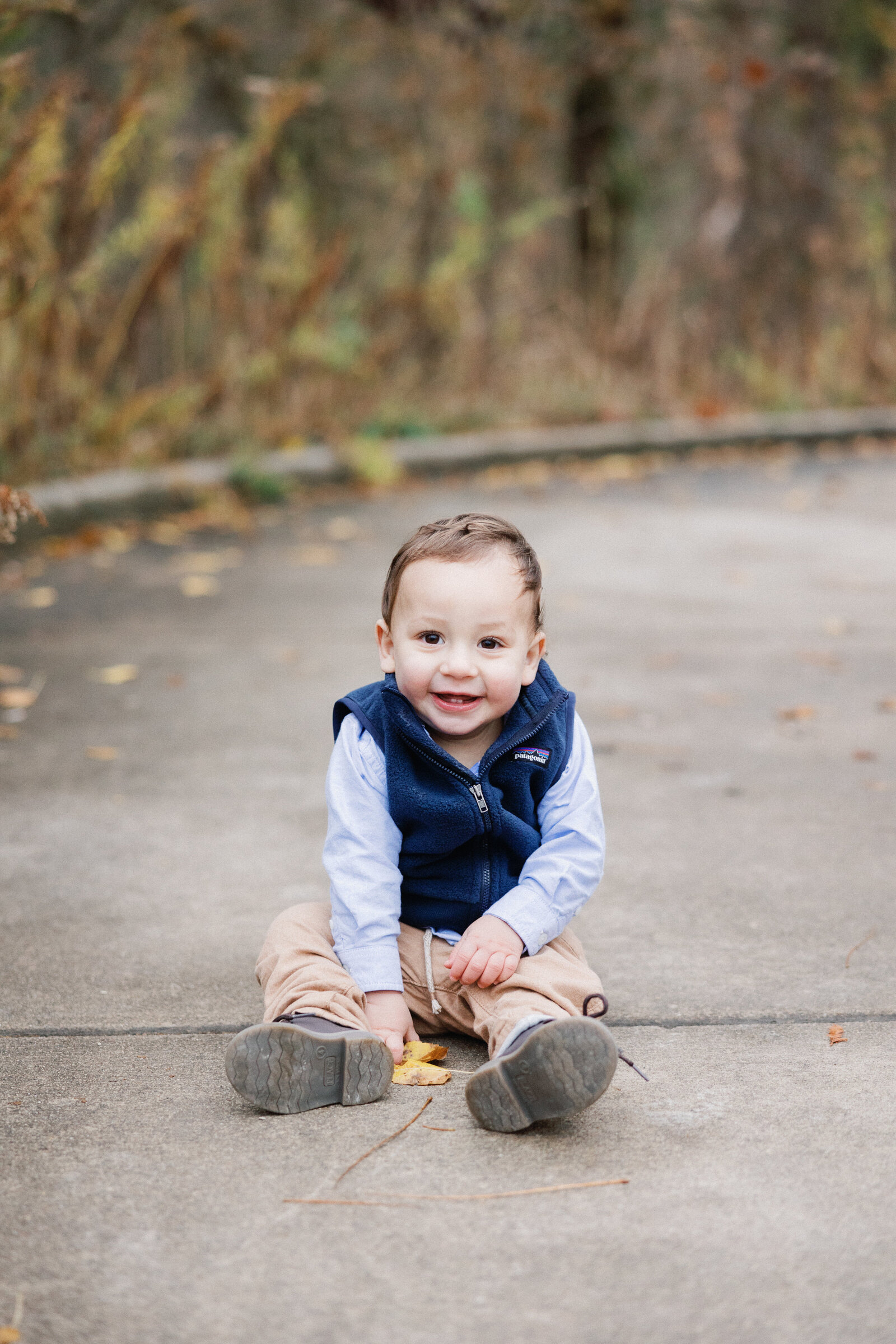 little boy laughing at the camera for family photos