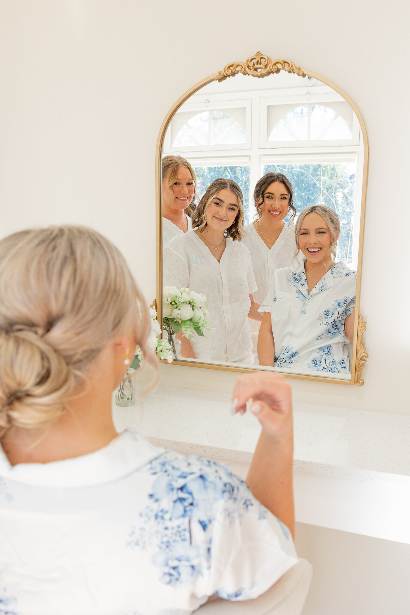 bridesmaids looking in mirror
