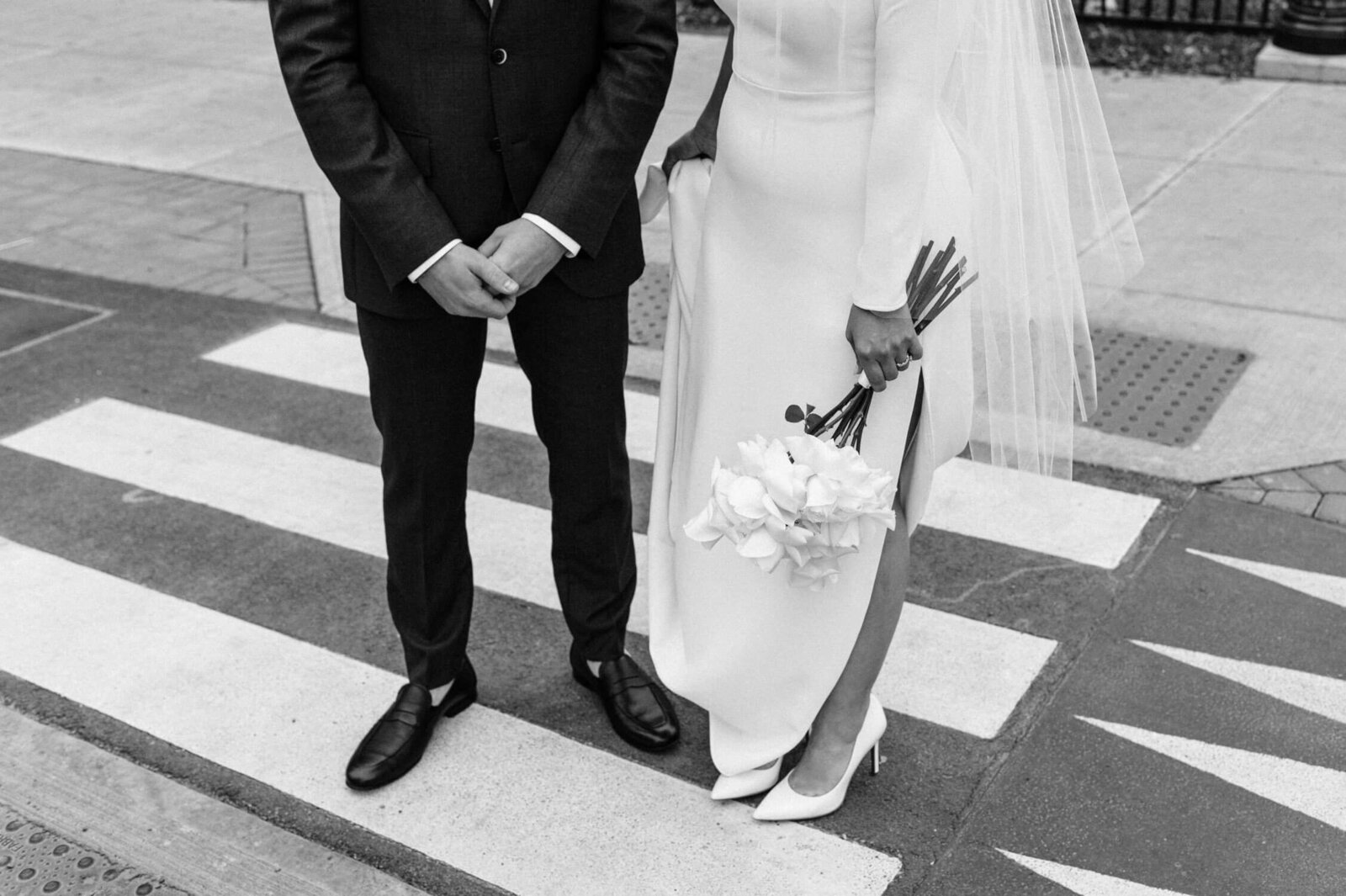 Closeup of bride and groom on crosswalk.