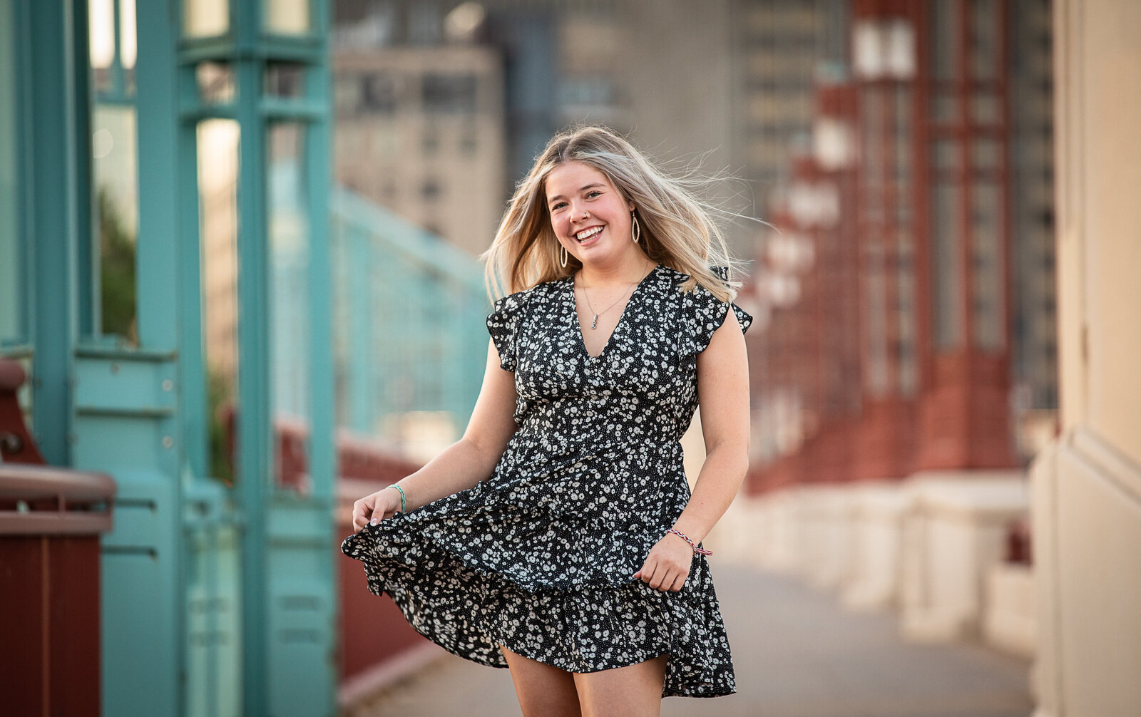 Young lady in white and black flower dress on bridge downtown