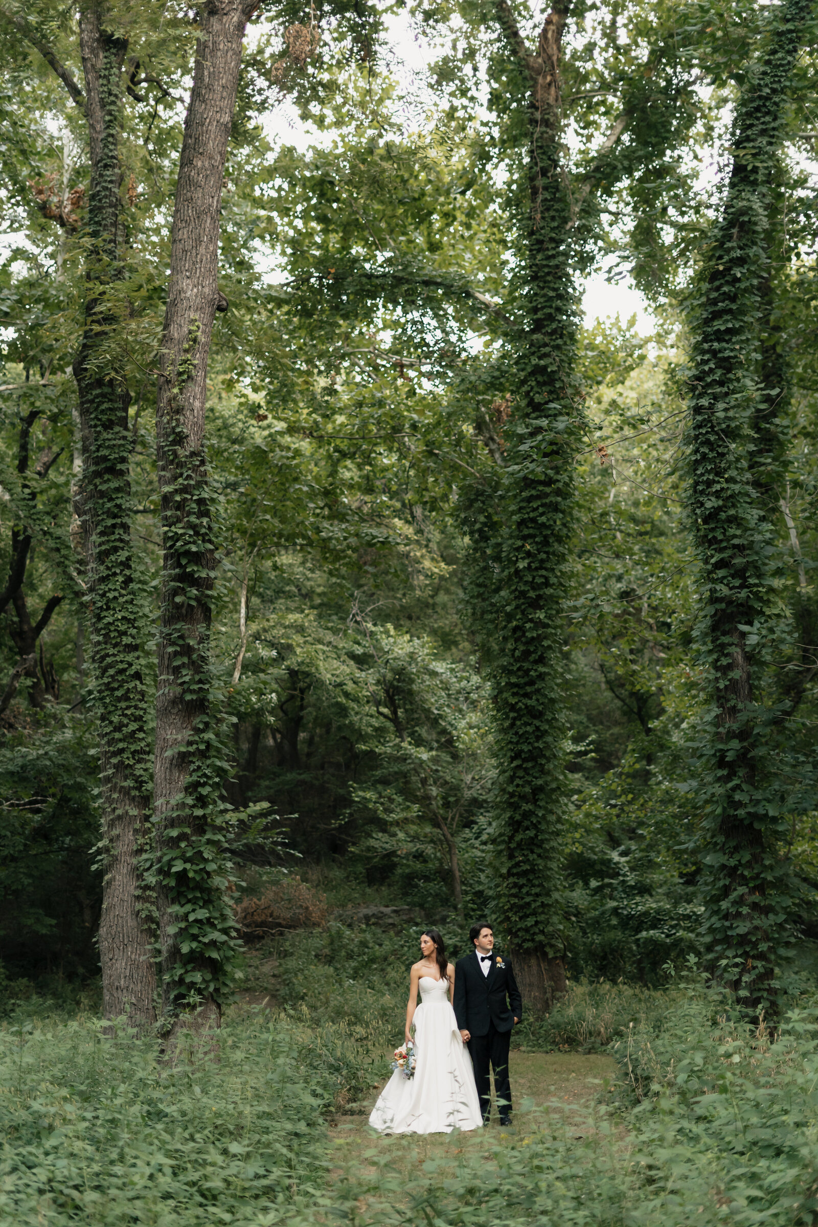 Enchanting forest elopement in the Pacific Northwest, with the bride and groom surrounded by towering trees.