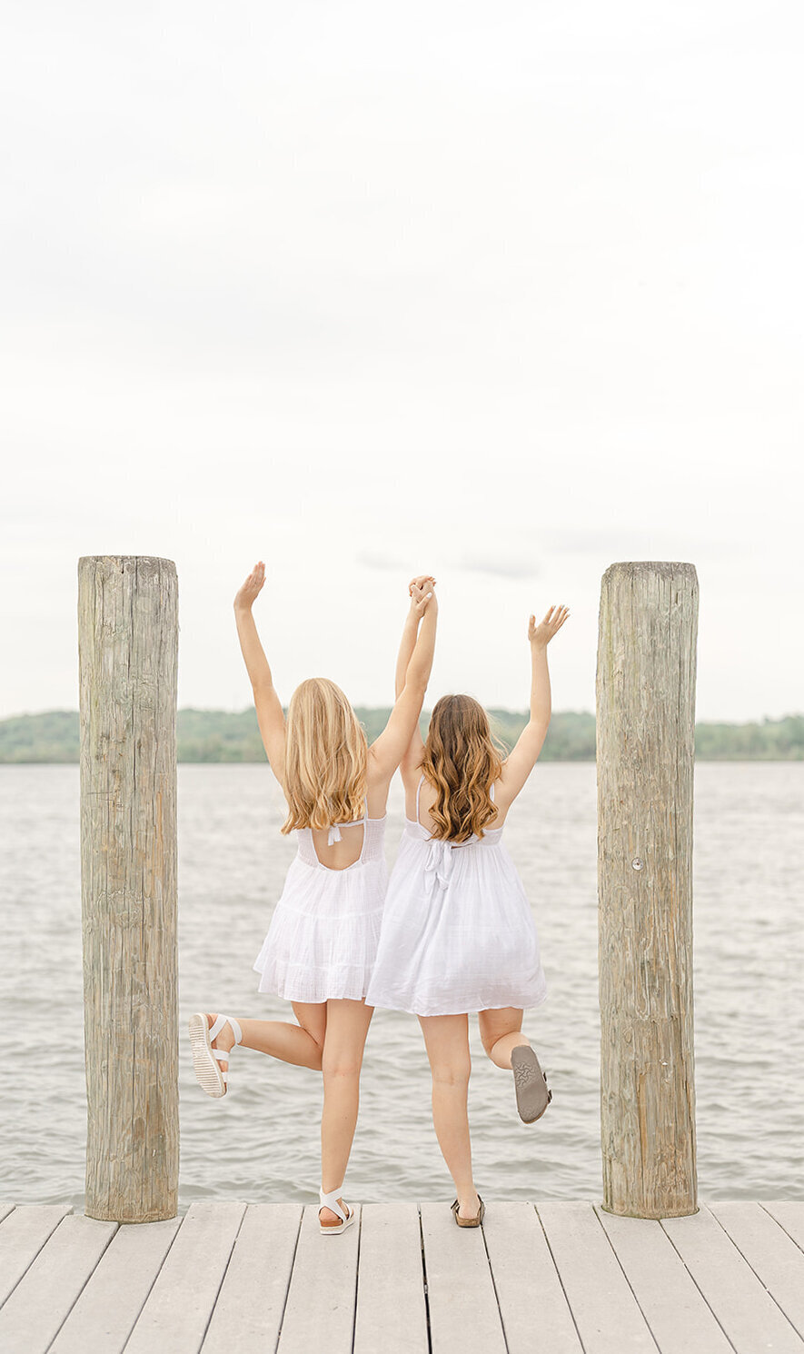 sisters looking out the water during senior photography in Prince William County, VA