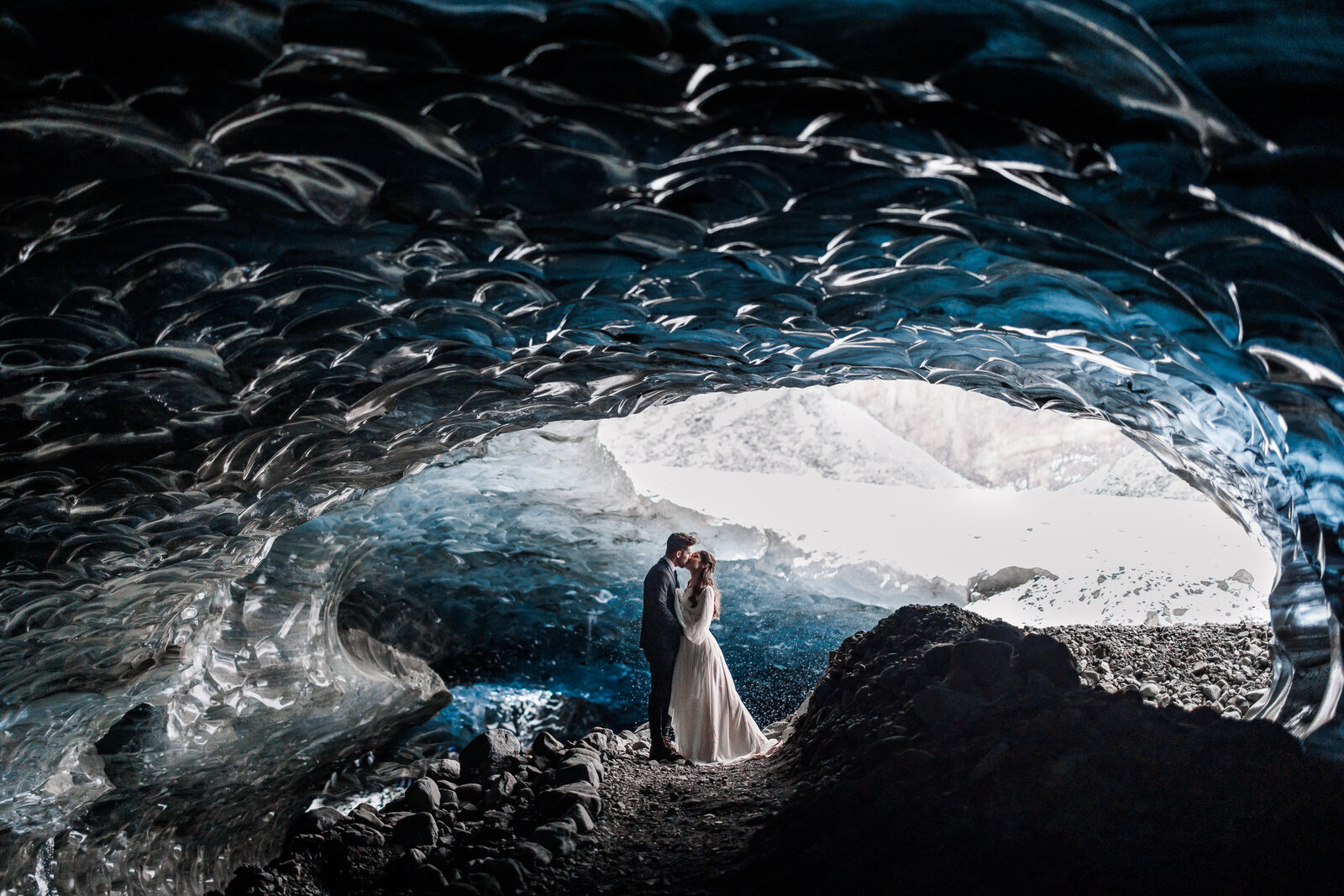 A couple elopes in a dreamy winter ice cave in Iceland.