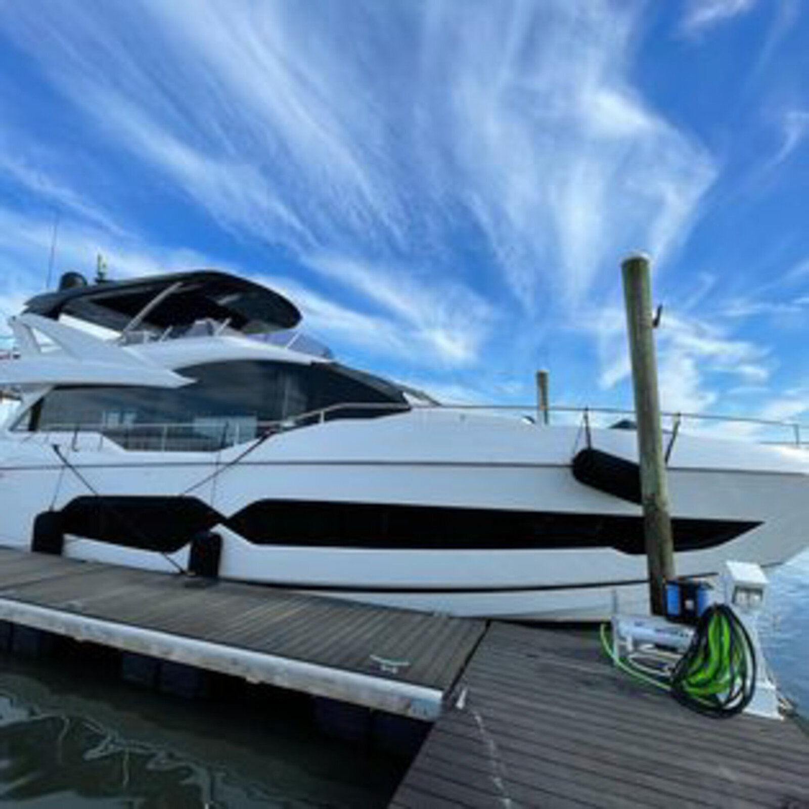 Luxury yacht docked with a clear blue sky
