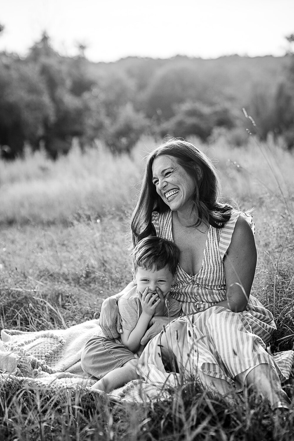 black and white portrait of mother and son in field