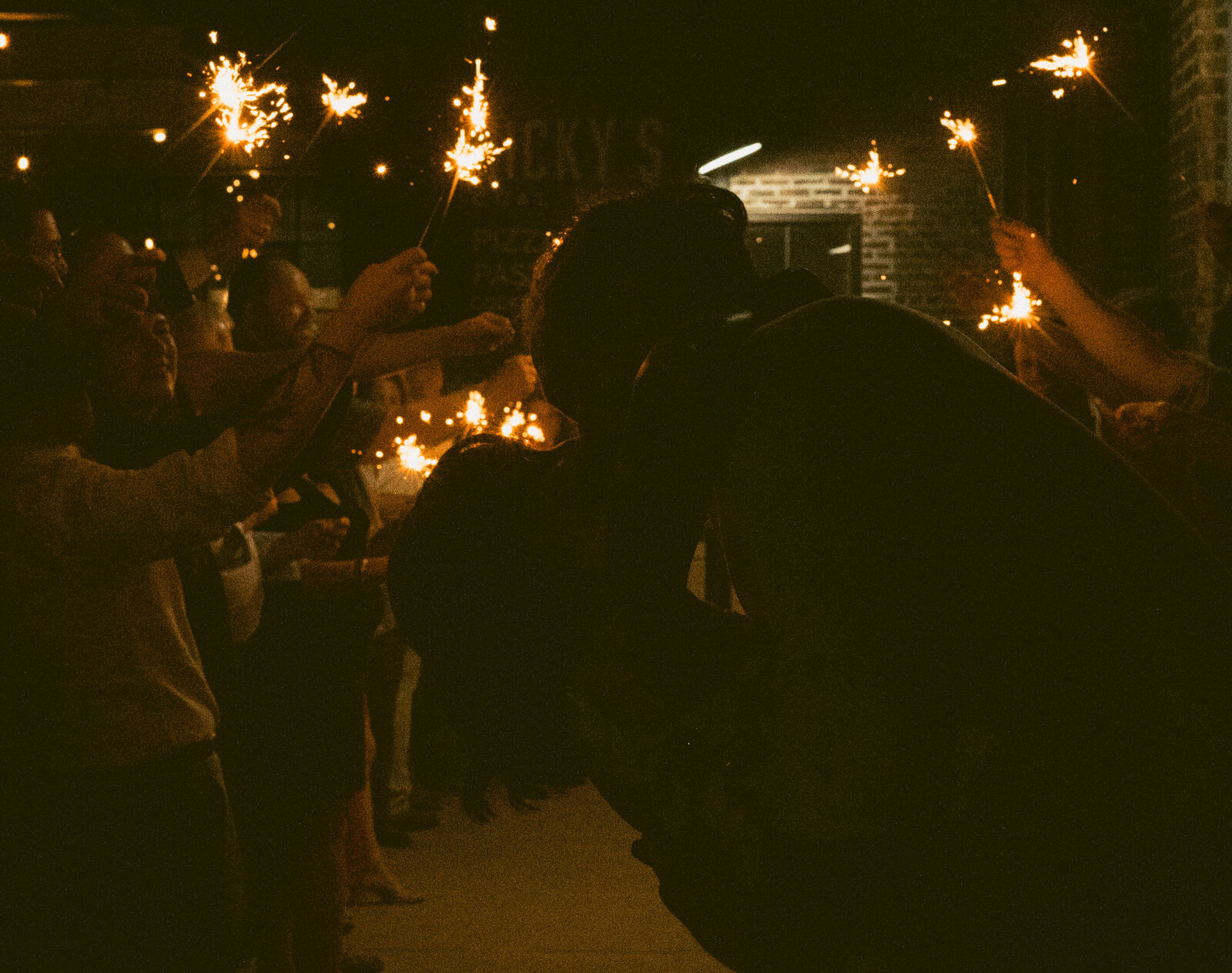 A married couple kissing after their sparkler exit from their Nashville wedding.