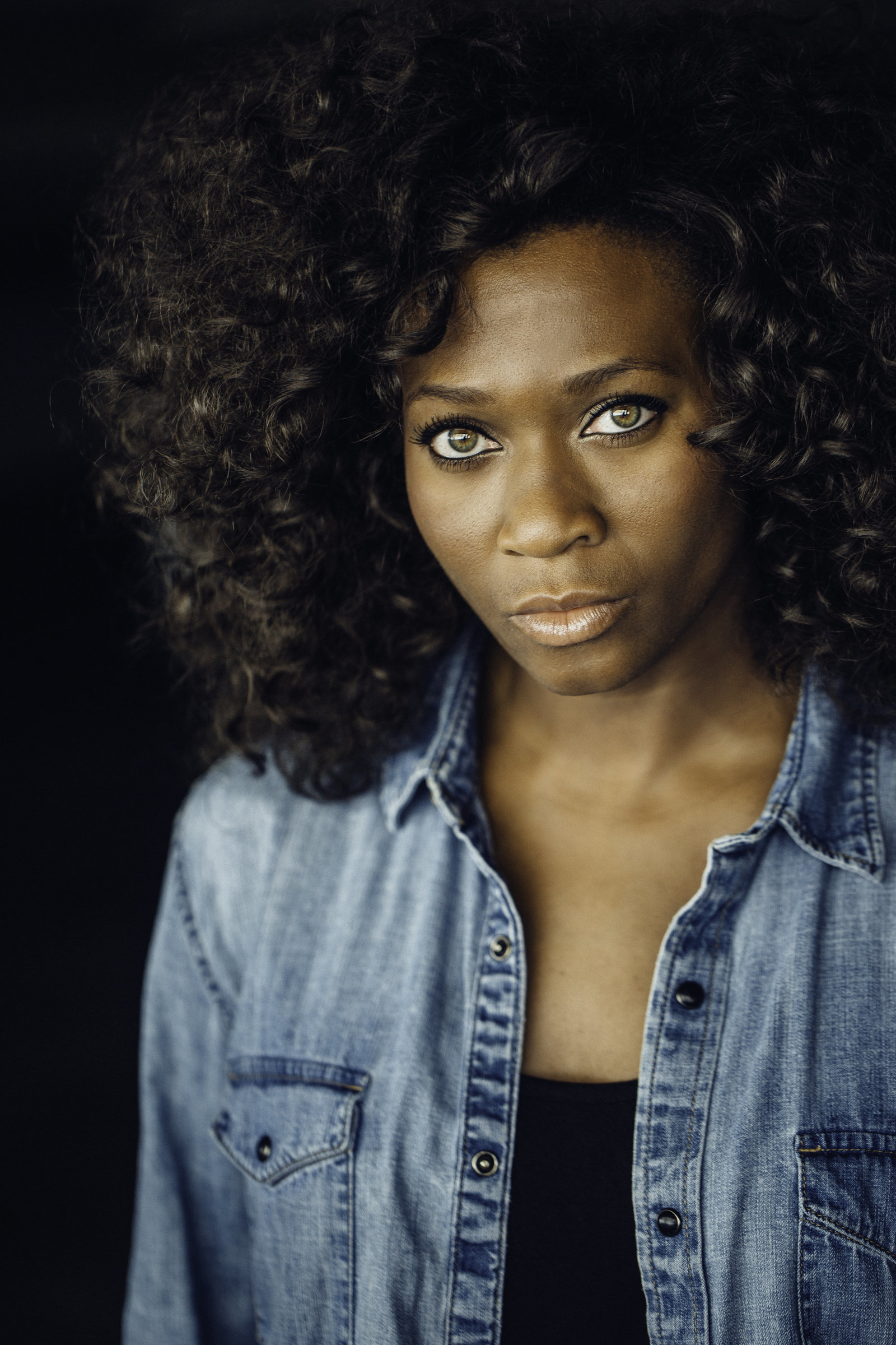 Headshot Photo Of Young Black Woman In Blue Denim Jacket And Black Tank Top