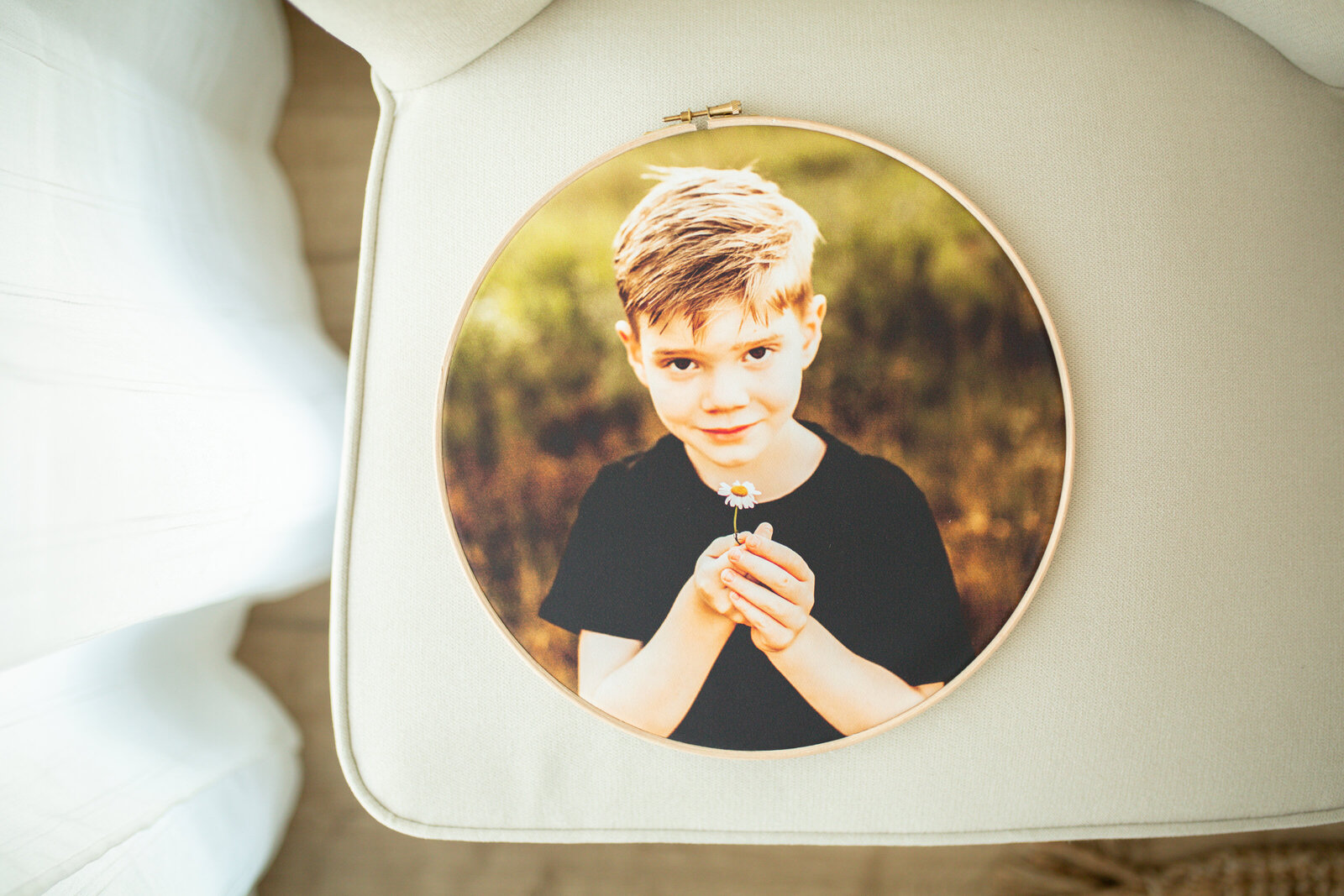 boy holding flower on canvas hoop frame