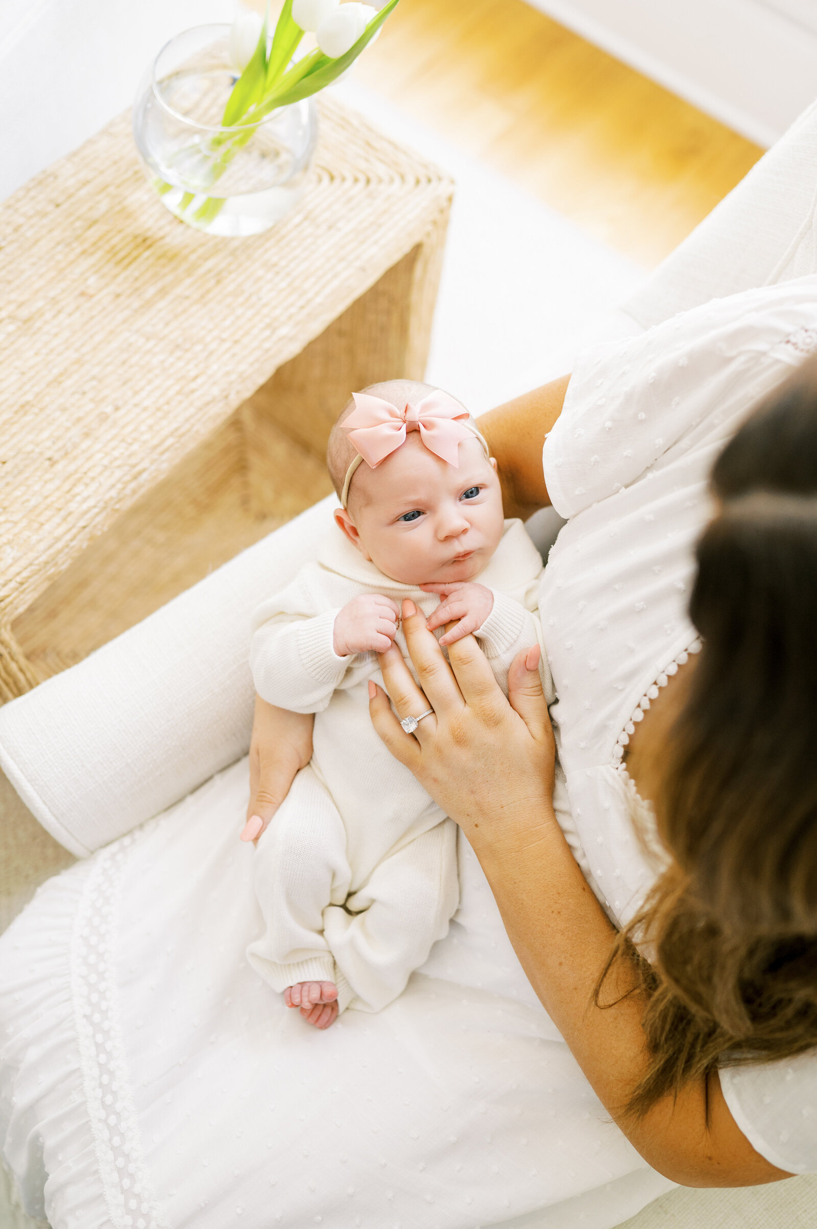 Mom holds newborn baby girl during at home newborn photography session in Raleigh North Carolina