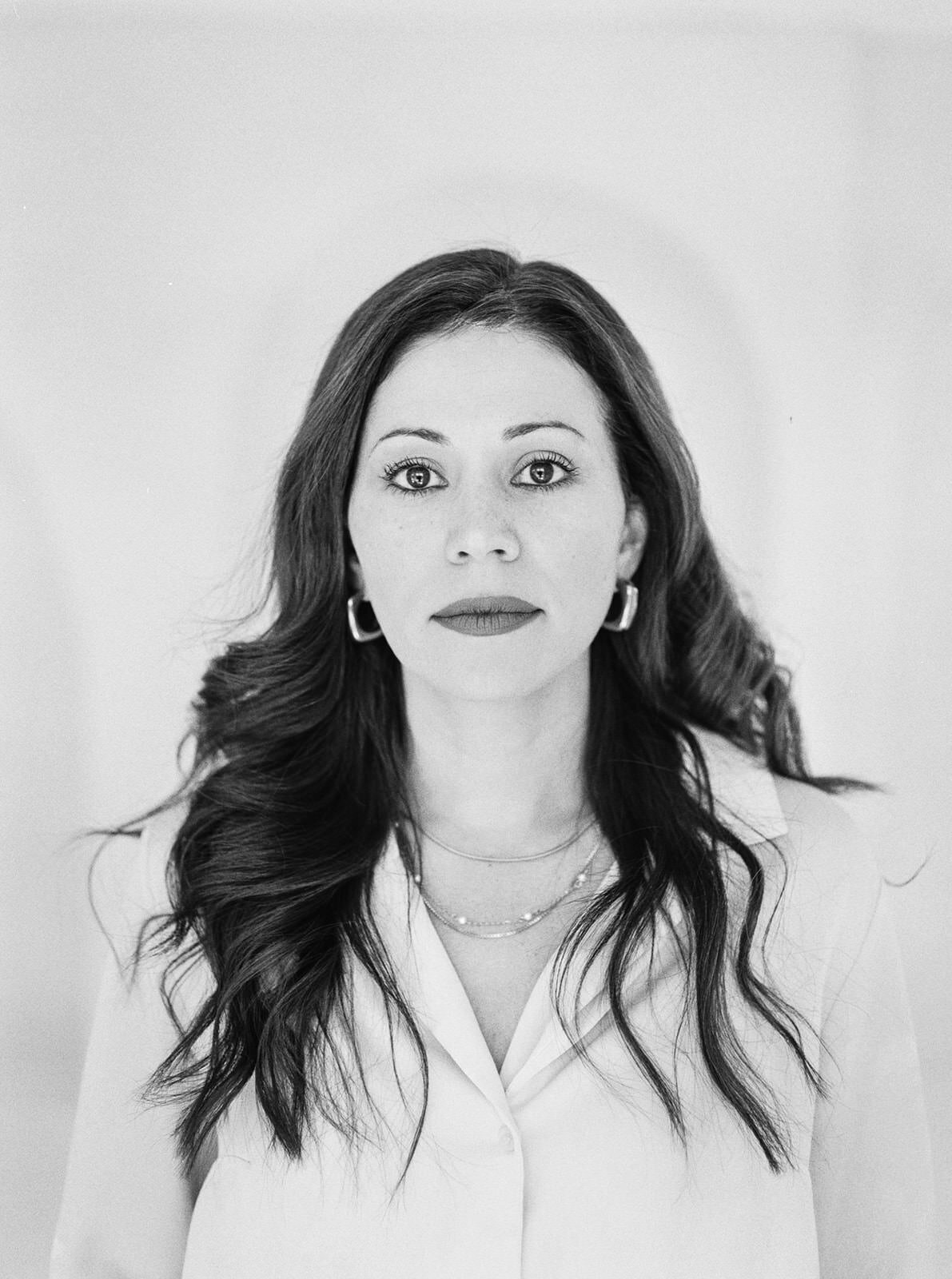 Elegant black-and-white portrait of a woman with long hair and a confident expression in Washington, DC.