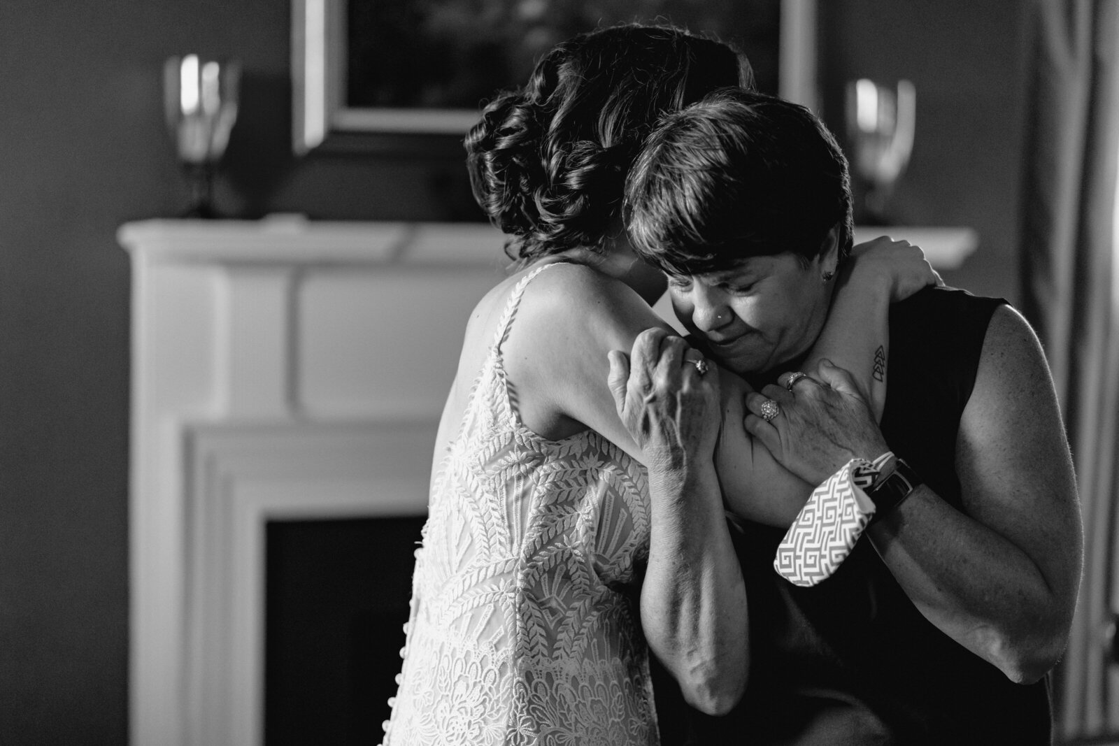 A bride hugs her crying mother