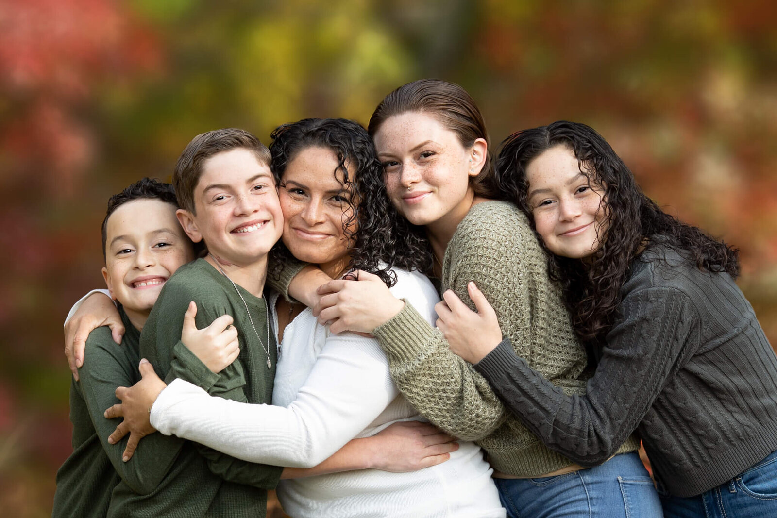 Fall family photo of mother and four children hugging