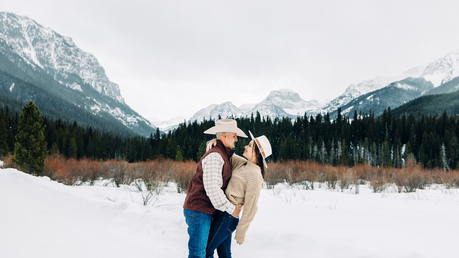 Couple in the snowy Rocky Mountains in Montana