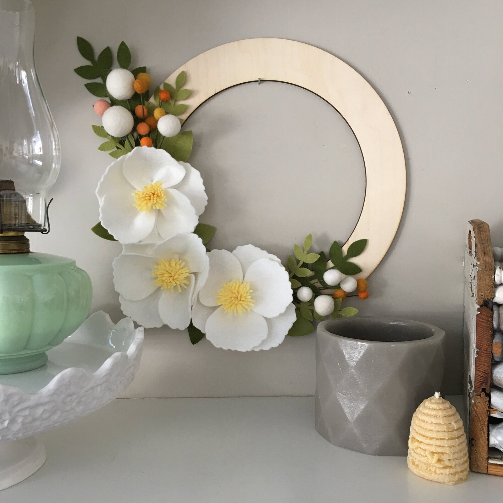 Felt flower wreath with large white flowers.