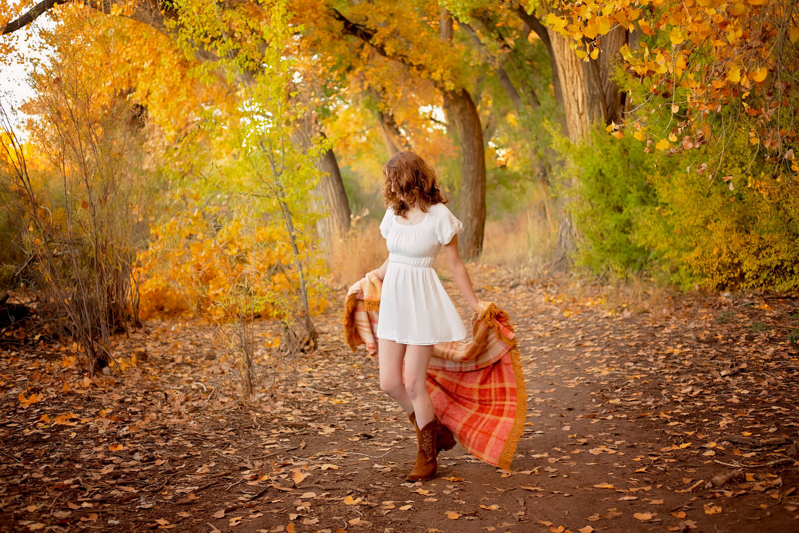 Senior-girl-session-spinning-with-a-blanket-fall-leaves