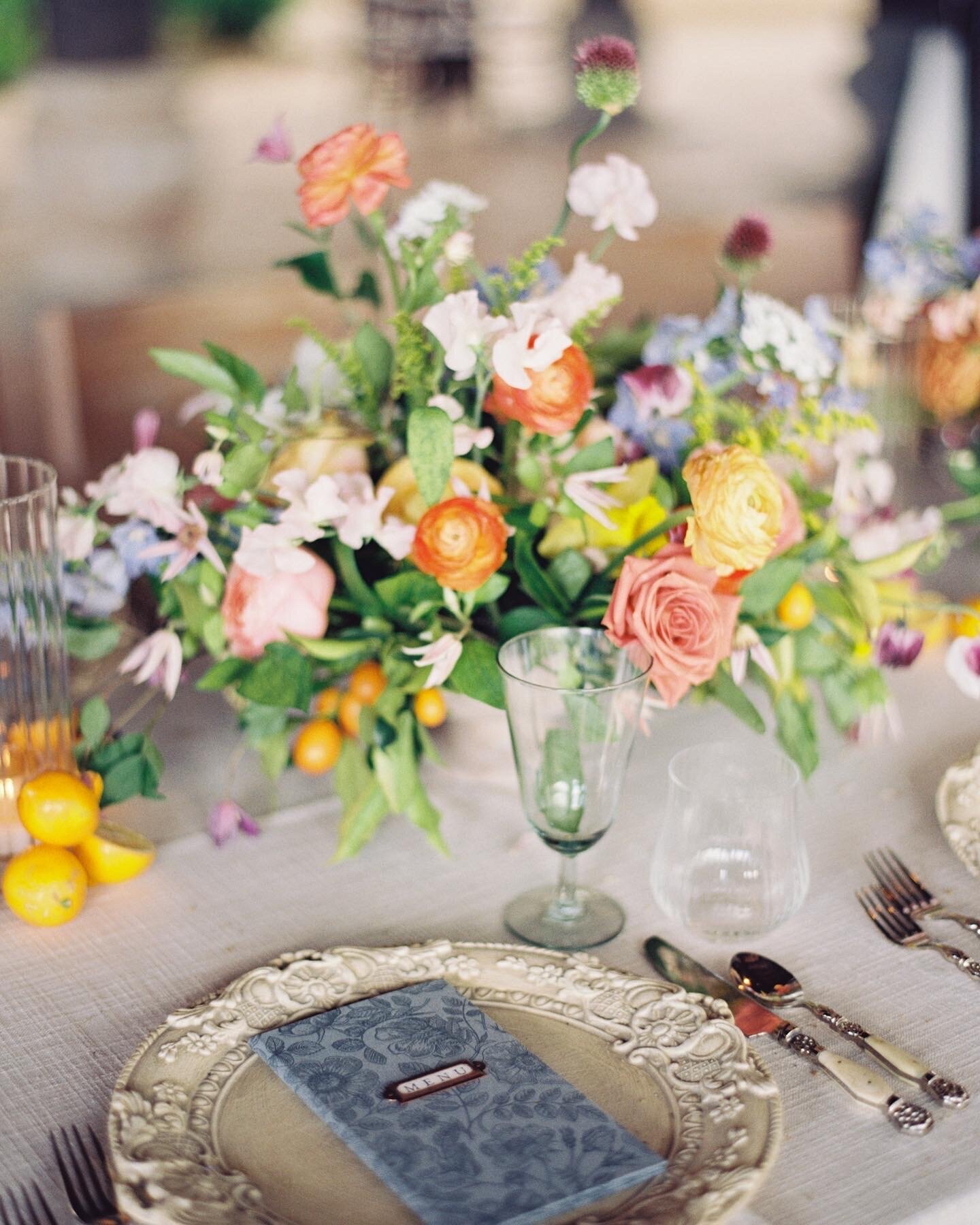 Colorful wedding tablescape featuring vibrant flowers and elegant settings, captured on film by Morgan Alysse, Louisiana film photographer.