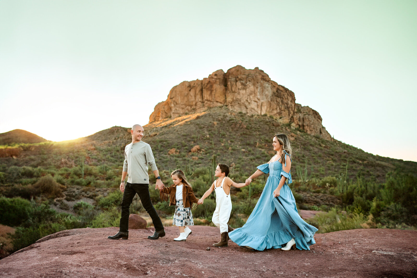 Family holding hands in desert