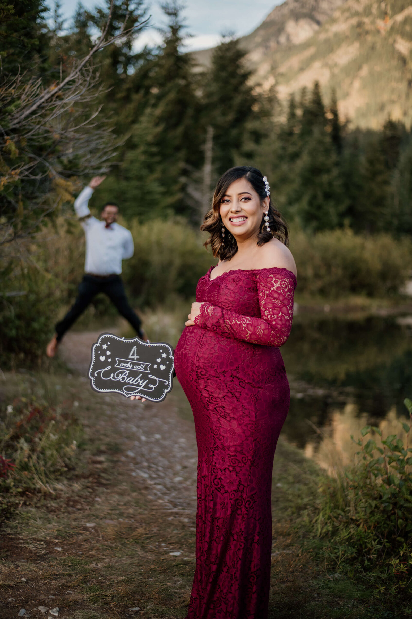 Mom-to-be holding countdown sign.