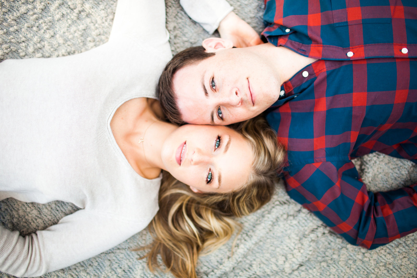 Couple laying on blanket with beautiful eyes