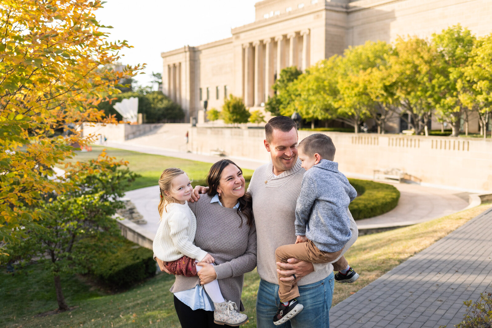 Kansas_City_Family_Photographer_Nelson_Atkins_Museum_of_Art_family_smiling_worlds_biggest_shuttlecock_in_background-19