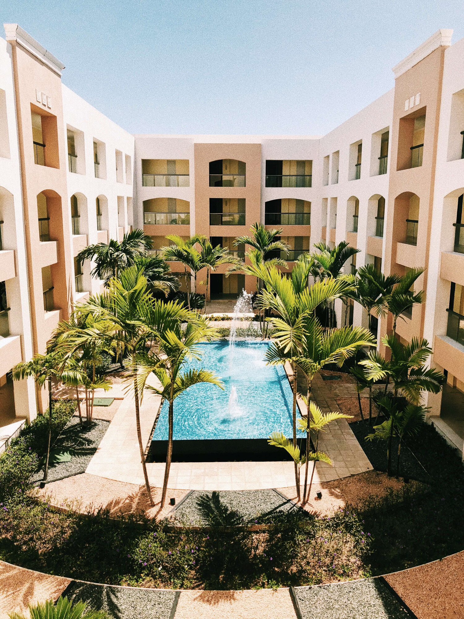 Beach resort that has a swimming pool in between their room building
