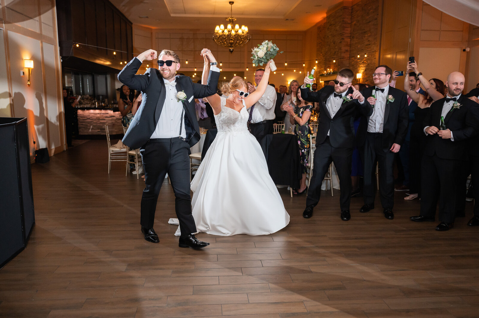 Bride and groom wearing sunglasses entering their wedding reception at the Madison
